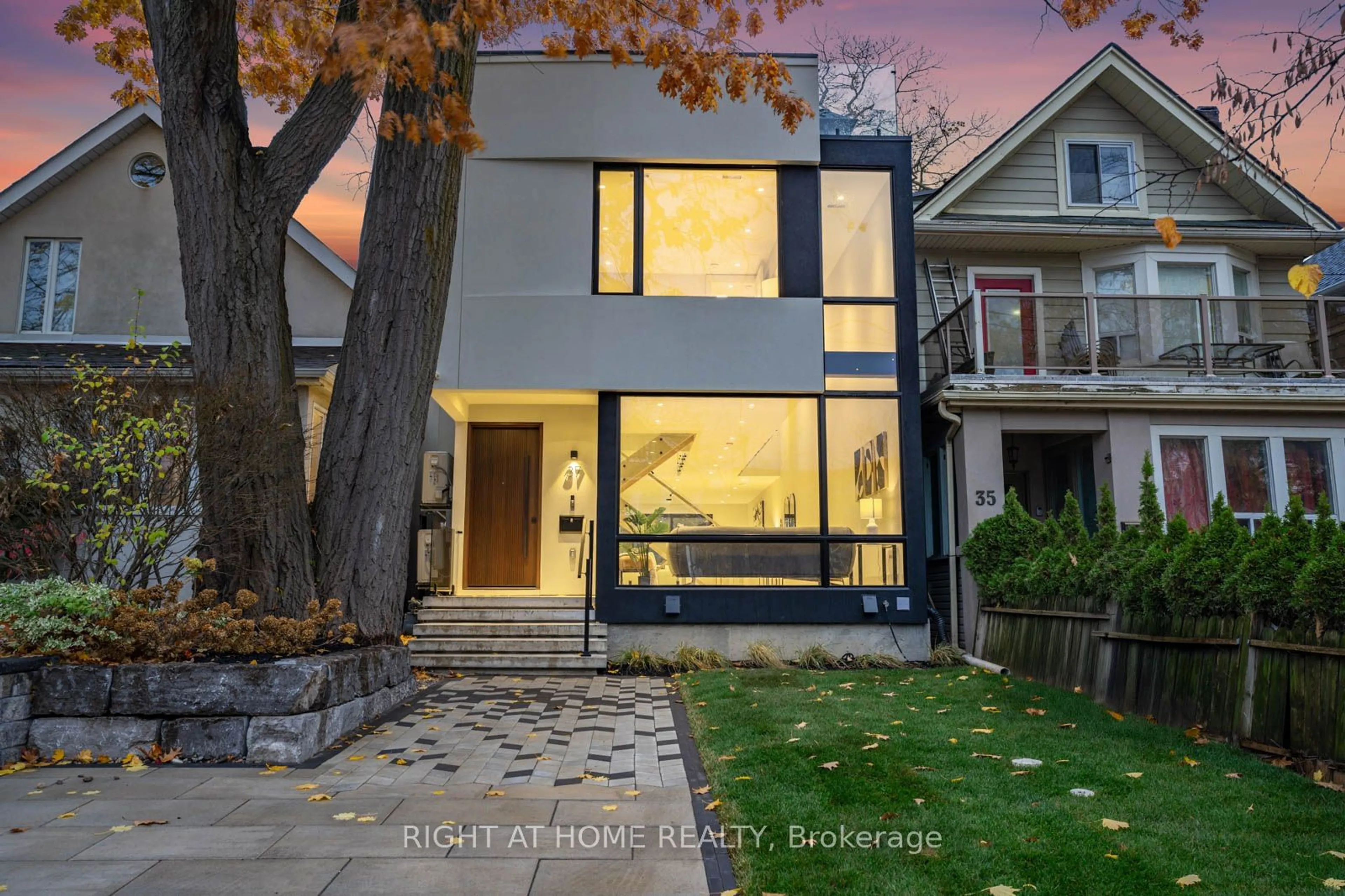 Frontside or backside of a home, the fenced backyard for 37 Kenilworth Ave, Toronto Ontario M4L 3S4