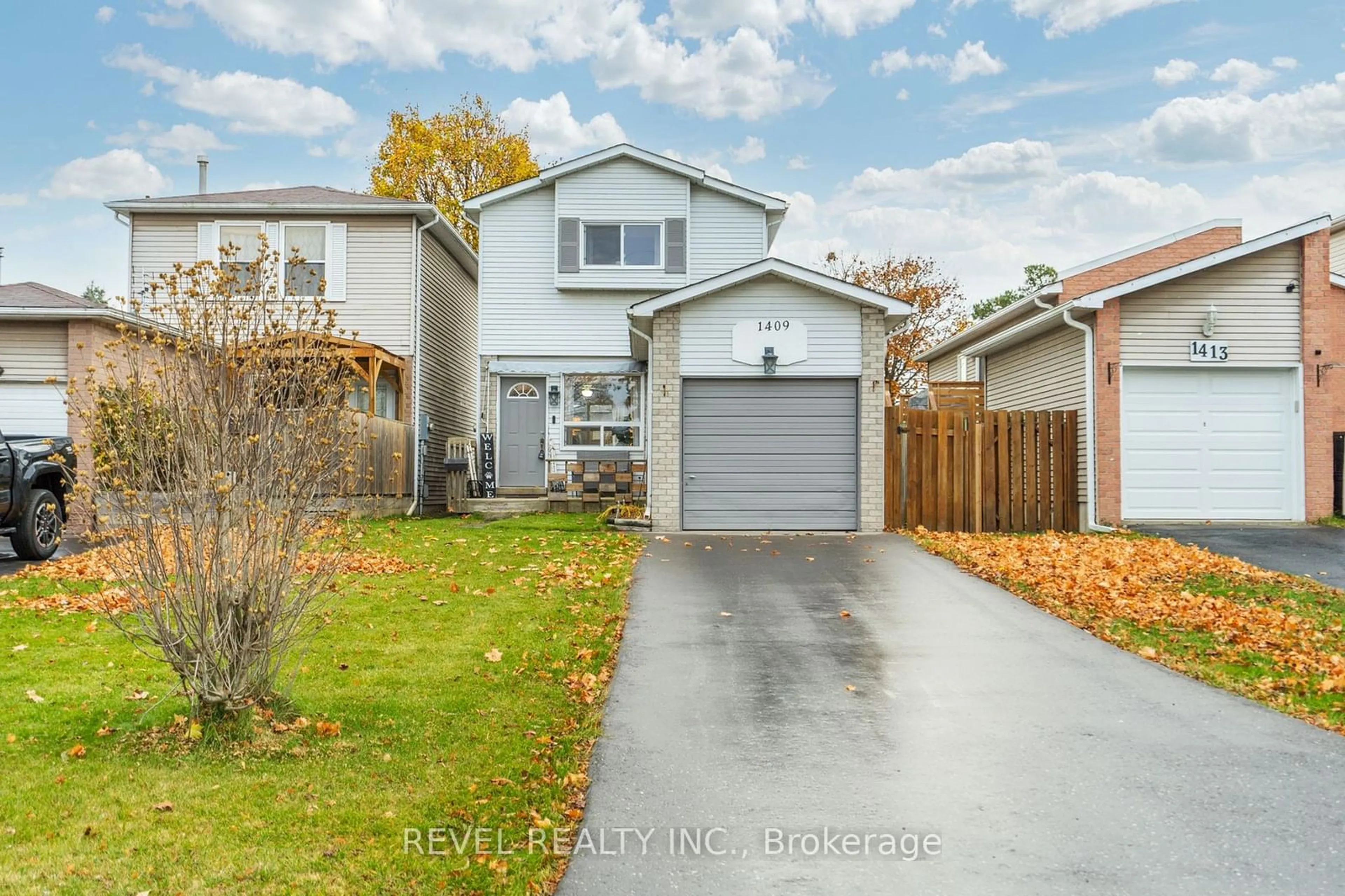 Frontside or backside of a home, the fenced backyard for 1409 Ritson Rd, Oshawa Ontario L1J 7M3