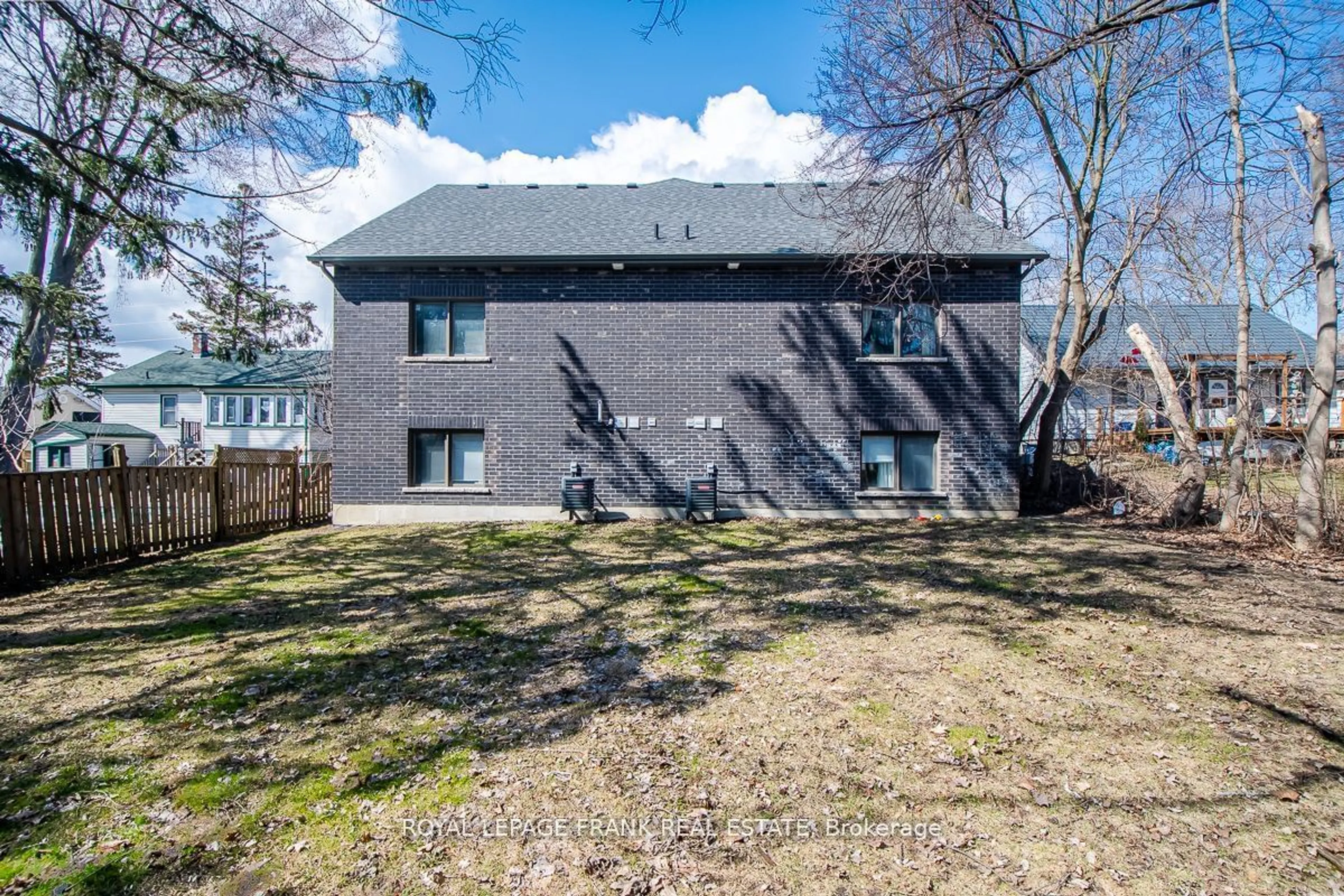 A pic from exterior of the house or condo, the fenced backyard for 805B Dundas St, Whitby Ontario L1N 2N6