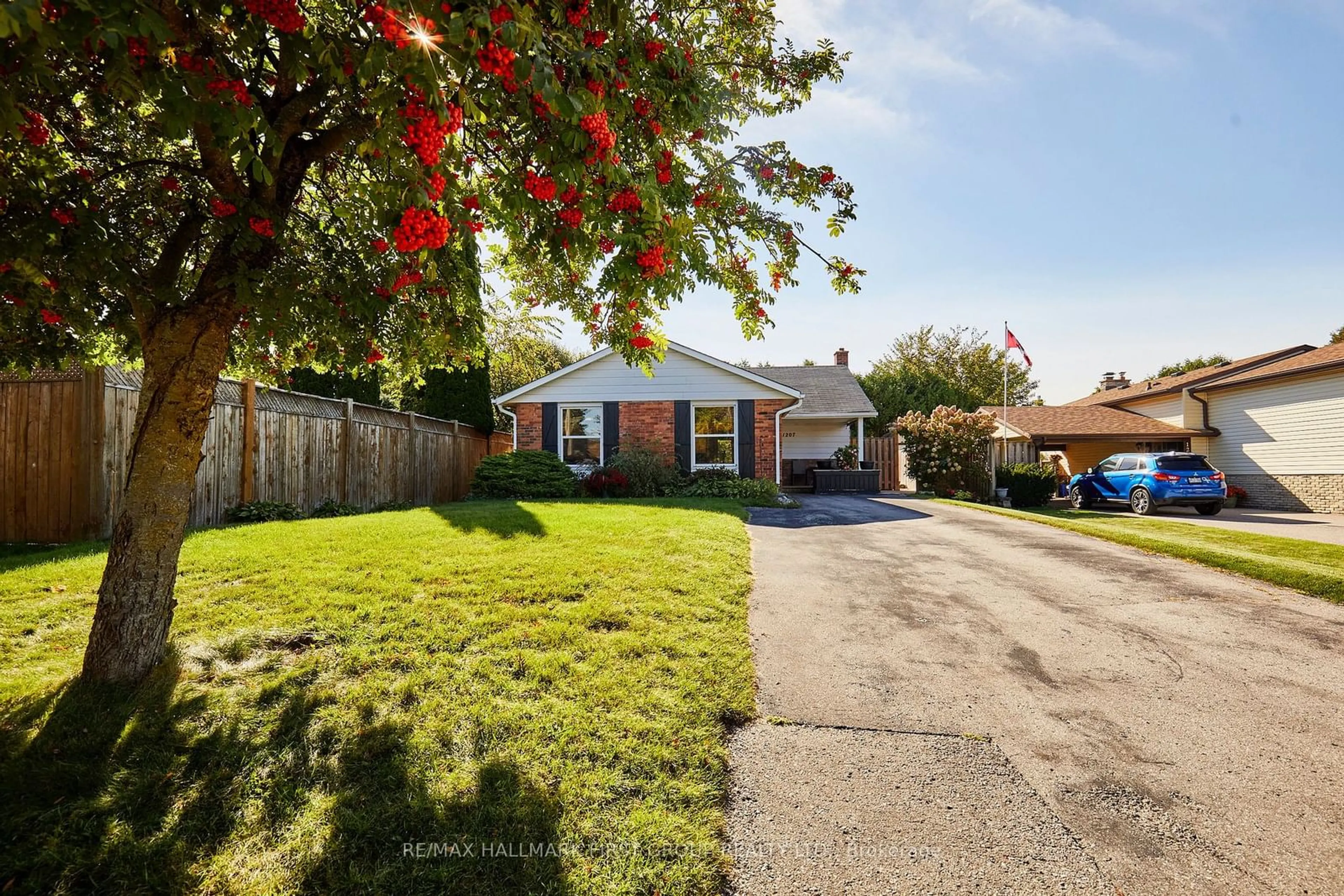 Frontside or backside of a home, the fenced backyard for 1207 Erinlea Ave, Oshawa Ontario L1H 7J4