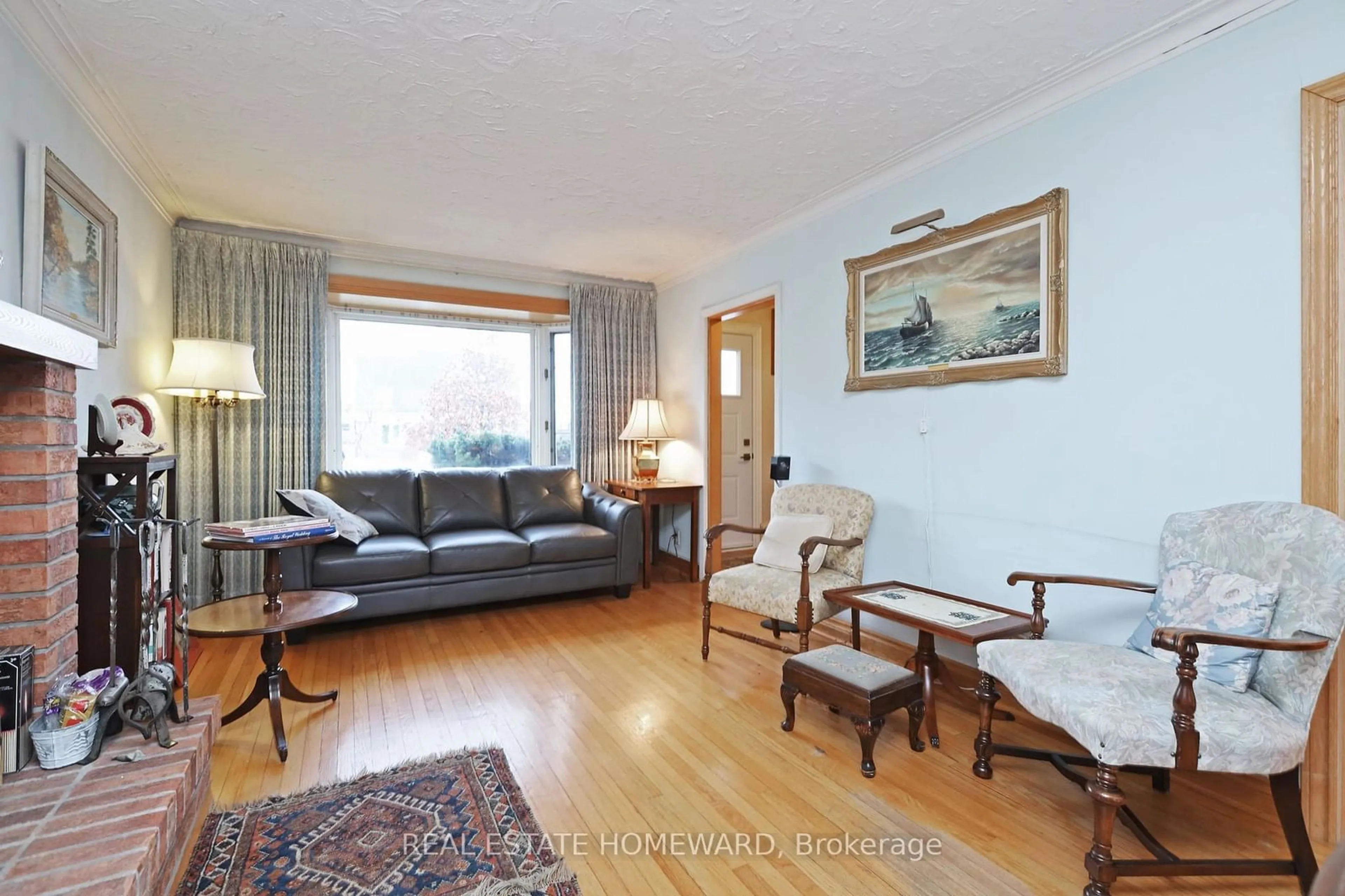 Living room with furniture, wood/laminate floor for 4 Eastgate Cres, Toronto Ontario M1L 1W9