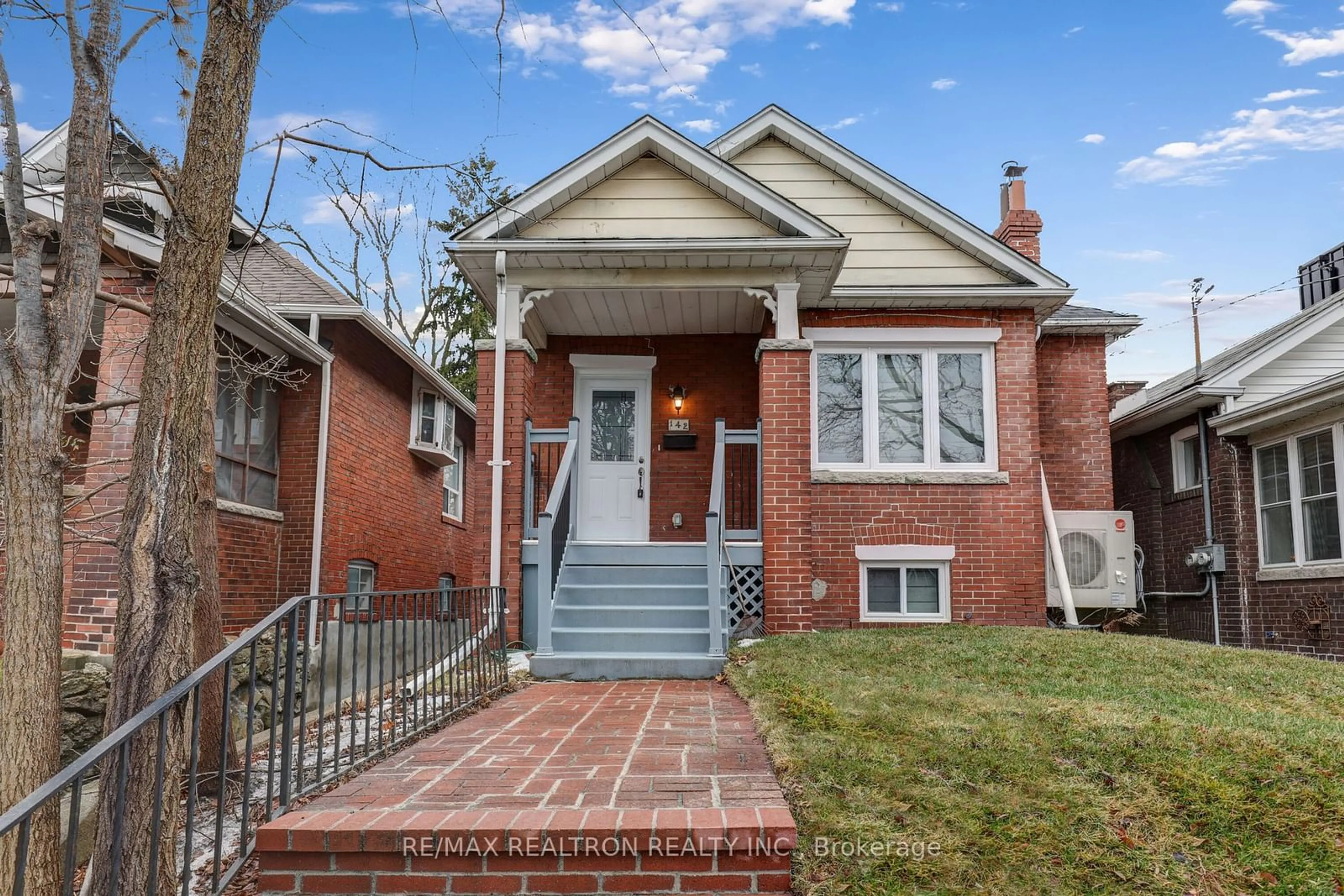 Home with brick exterior material, street for 142 Eastwood Rd, Toronto Ontario M4L 2C9