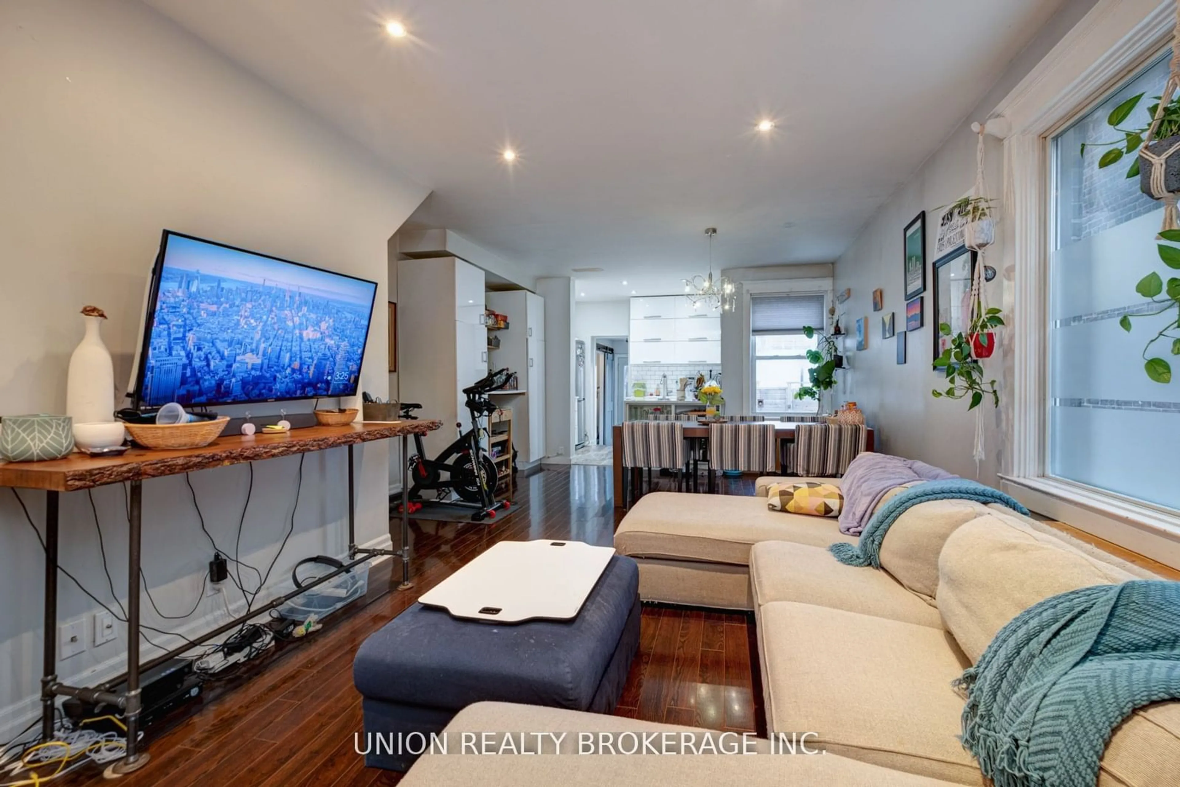 Living room with furniture, wood/laminate floor for 45 Strathmore Blvd, Toronto Ontario M4C 1N5