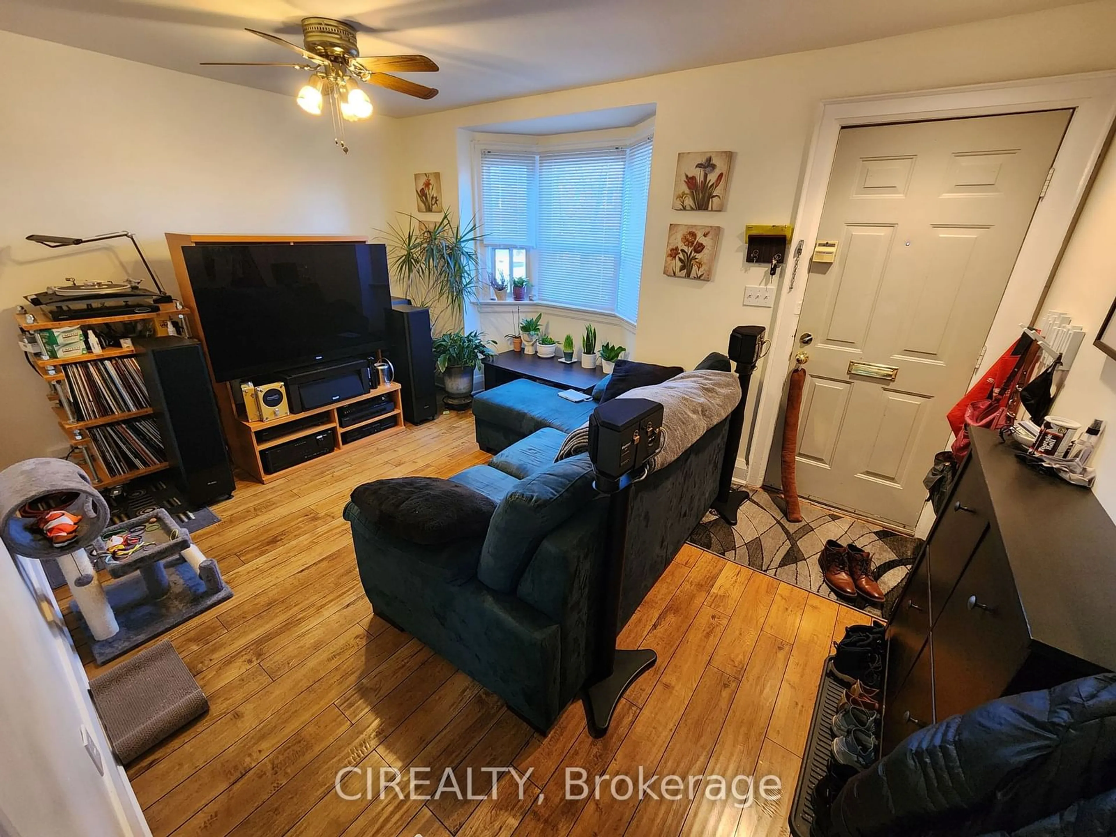 Living room with furniture, wood/laminate floor for 1017 Greenwood Ave, Toronto Ontario M4J 4C9