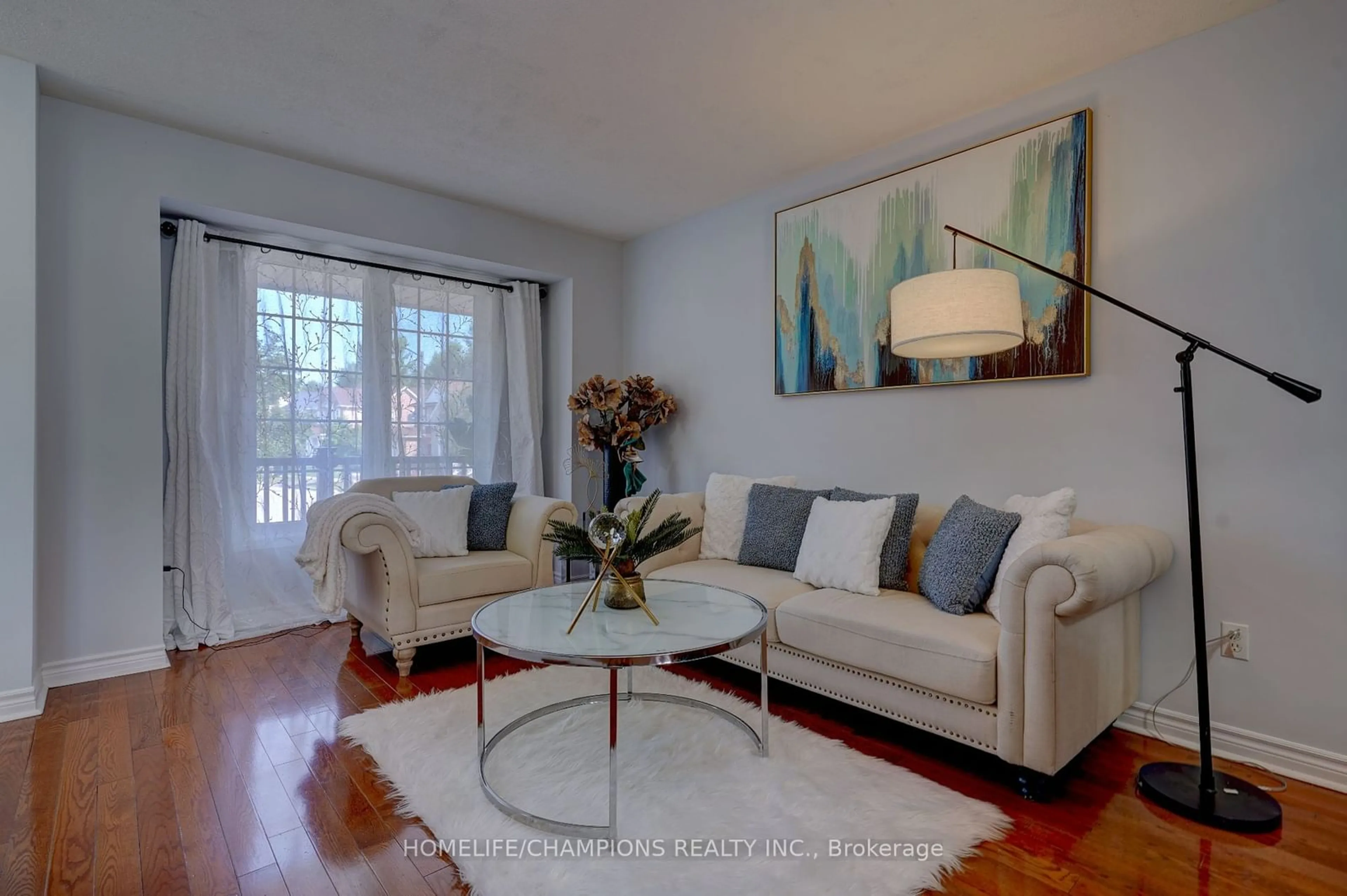 Living room with furniture, wood/laminate floor for 145 Raponi Circ, Toronto Ontario M1X 2C6