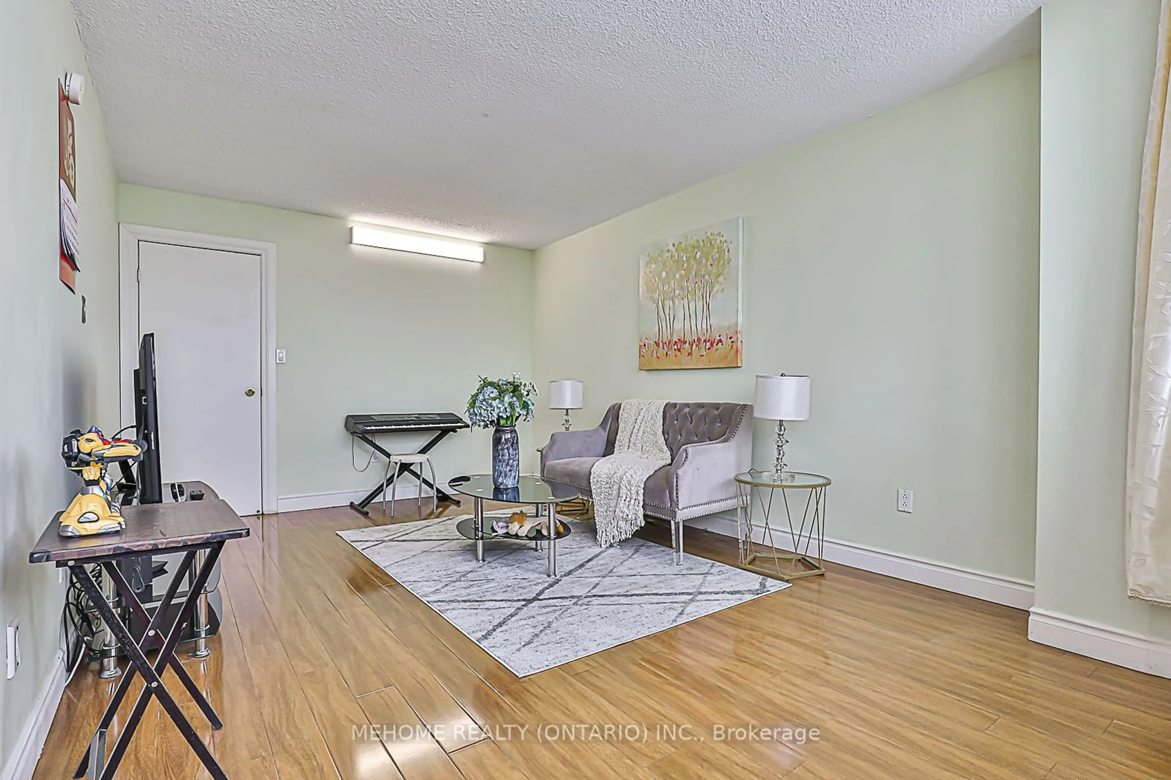 Living room with furniture, wood/laminate floor for 100 Echo Pt #1910, Toronto Ontario M1W 2V2