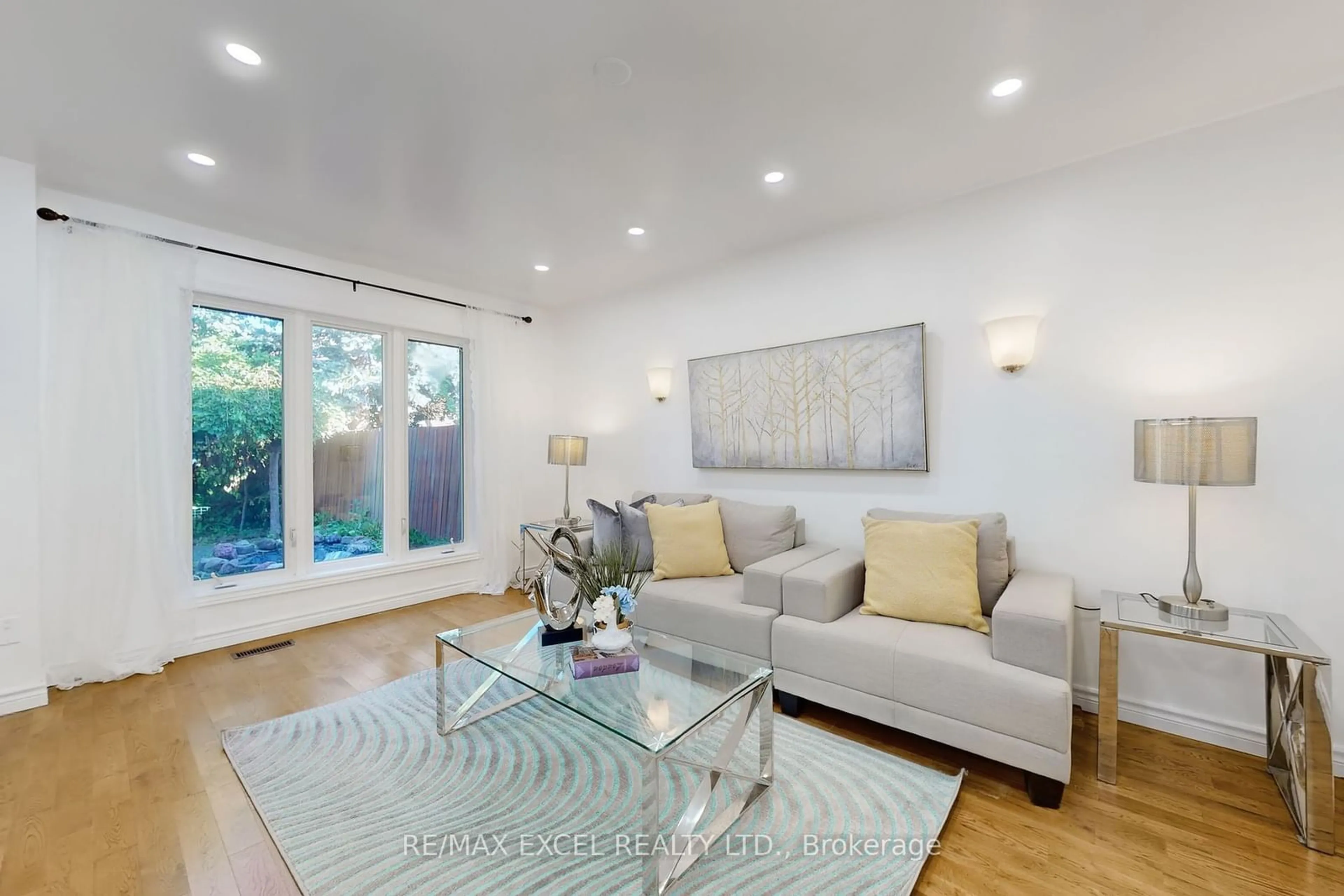 Living room with furniture, wood/laminate floor for 49 Ambercroft Blvd, Toronto Ontario M1W 2Z6