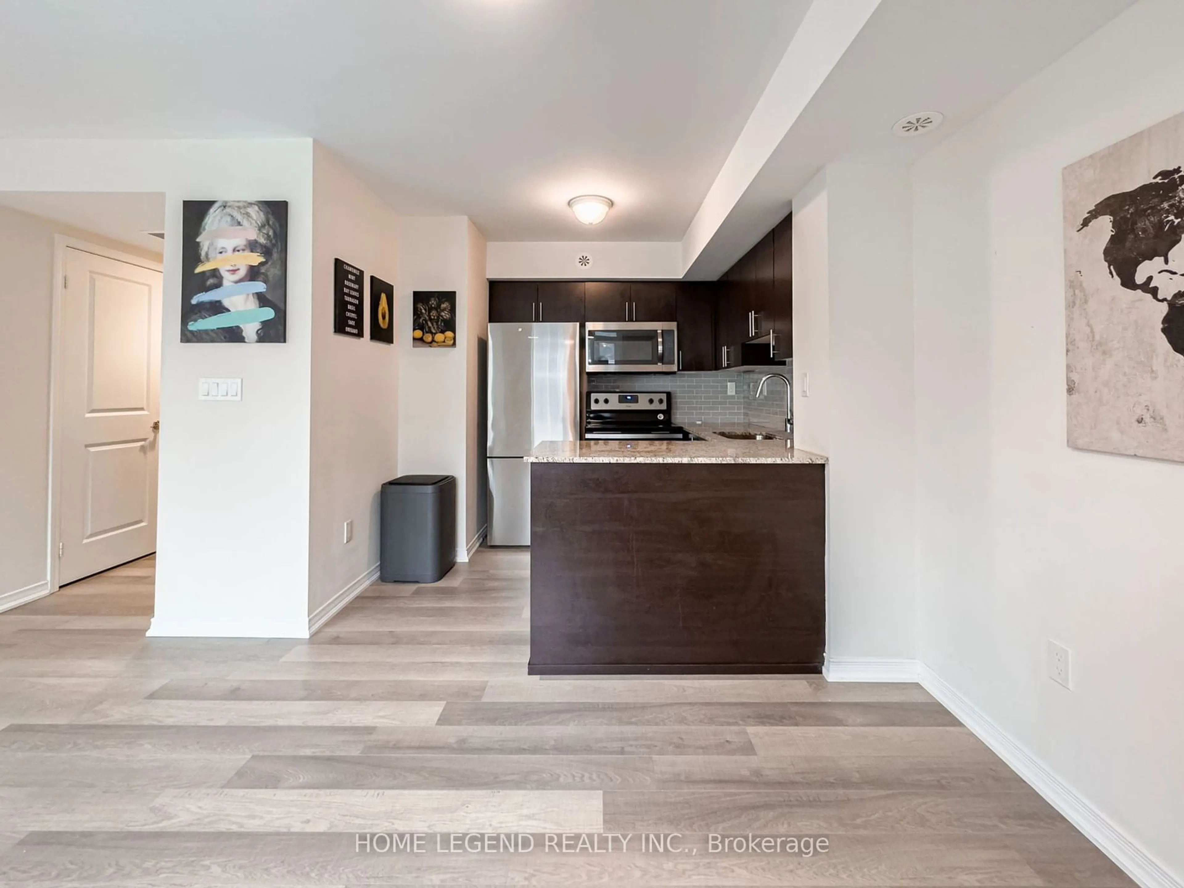 Open concept kitchen, wood/laminate floor for 80 Orchid Place Dr #306, Toronto Ontario M1B 0C4