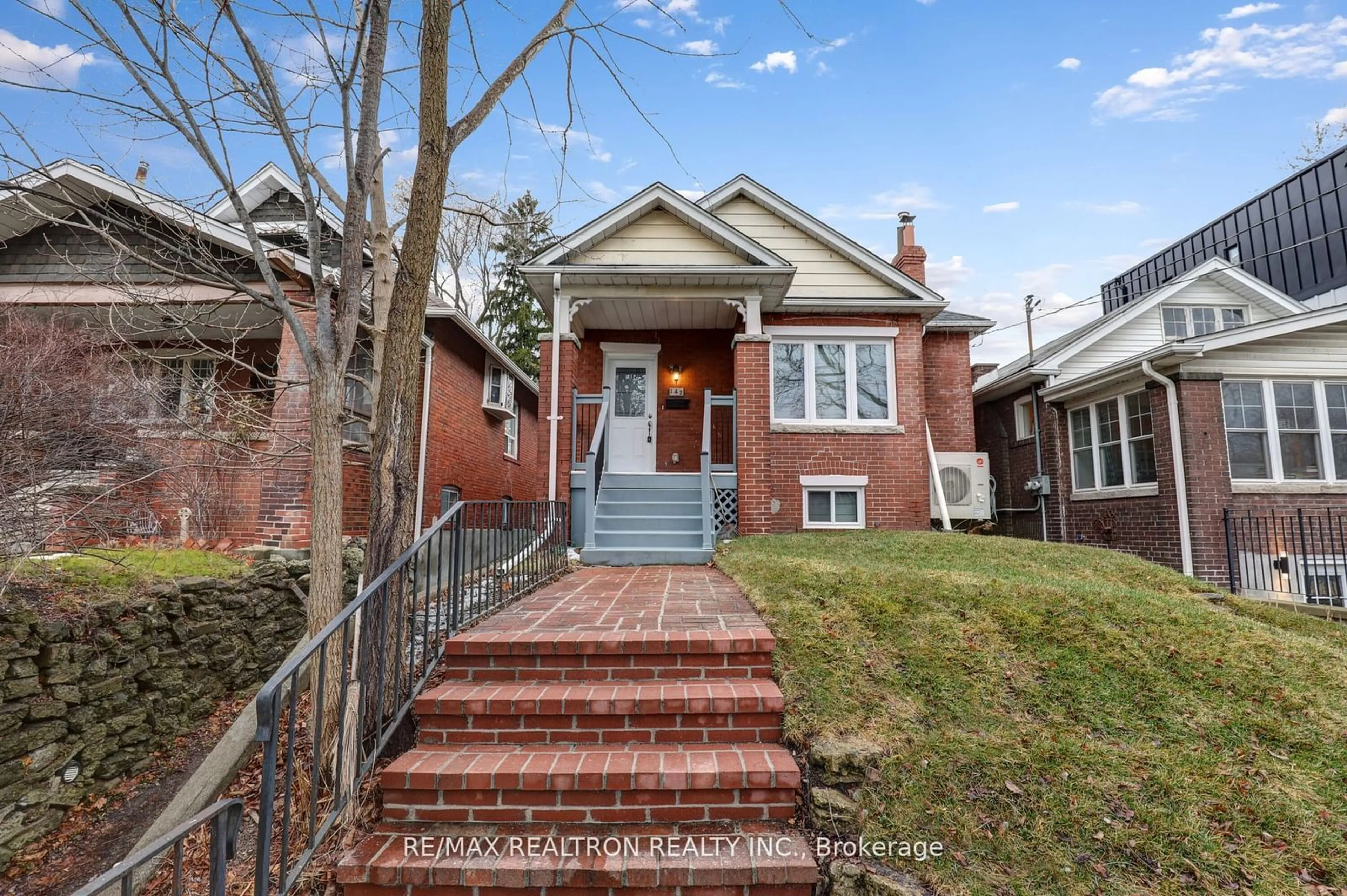 Home with brick exterior material, street for 142 Eastwood Rd, Toronto Ontario M4L 2C9