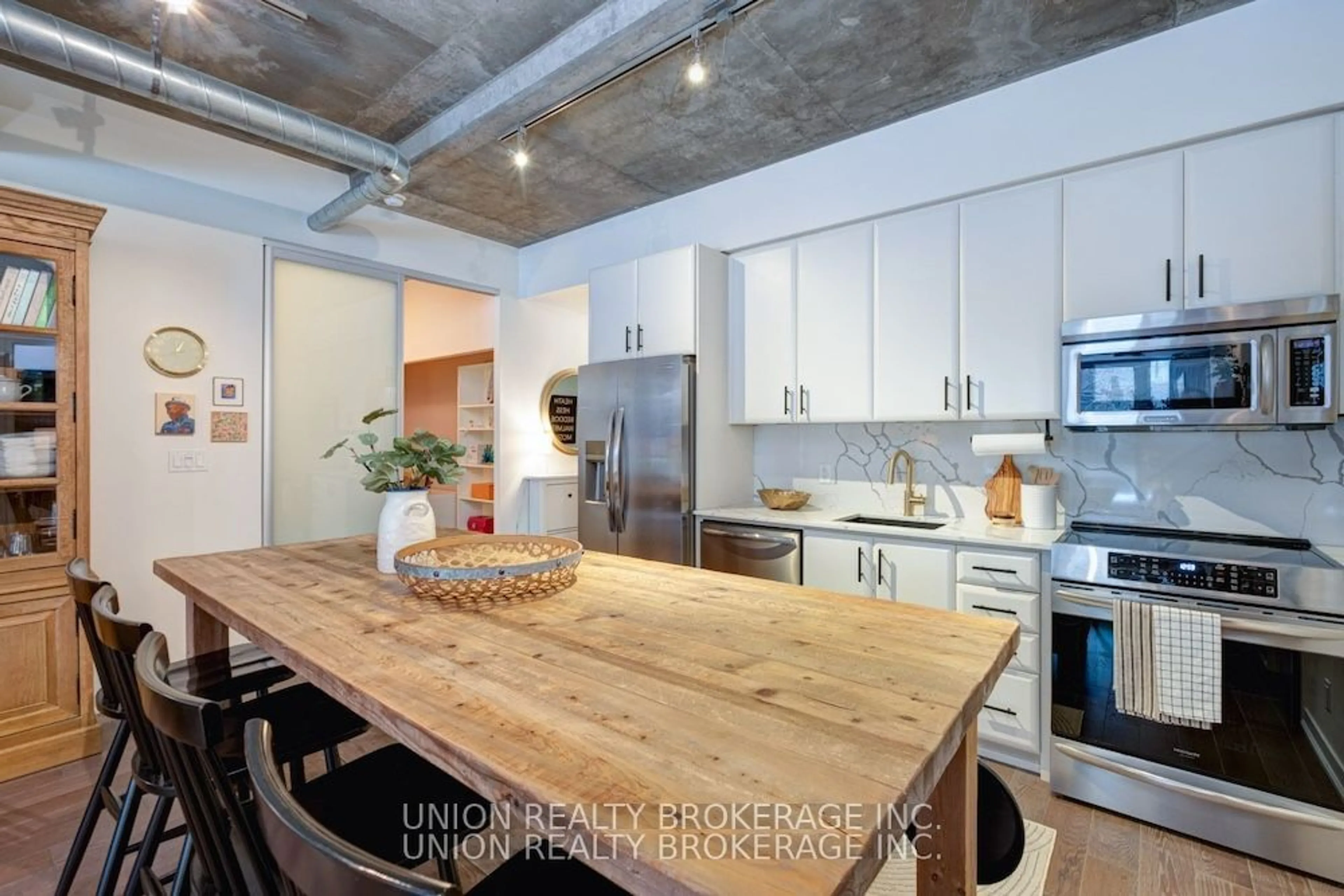 Open concept kitchen, cement floor for 201 Carlaw Ave #105, Toronto Ontario M4M 2S3