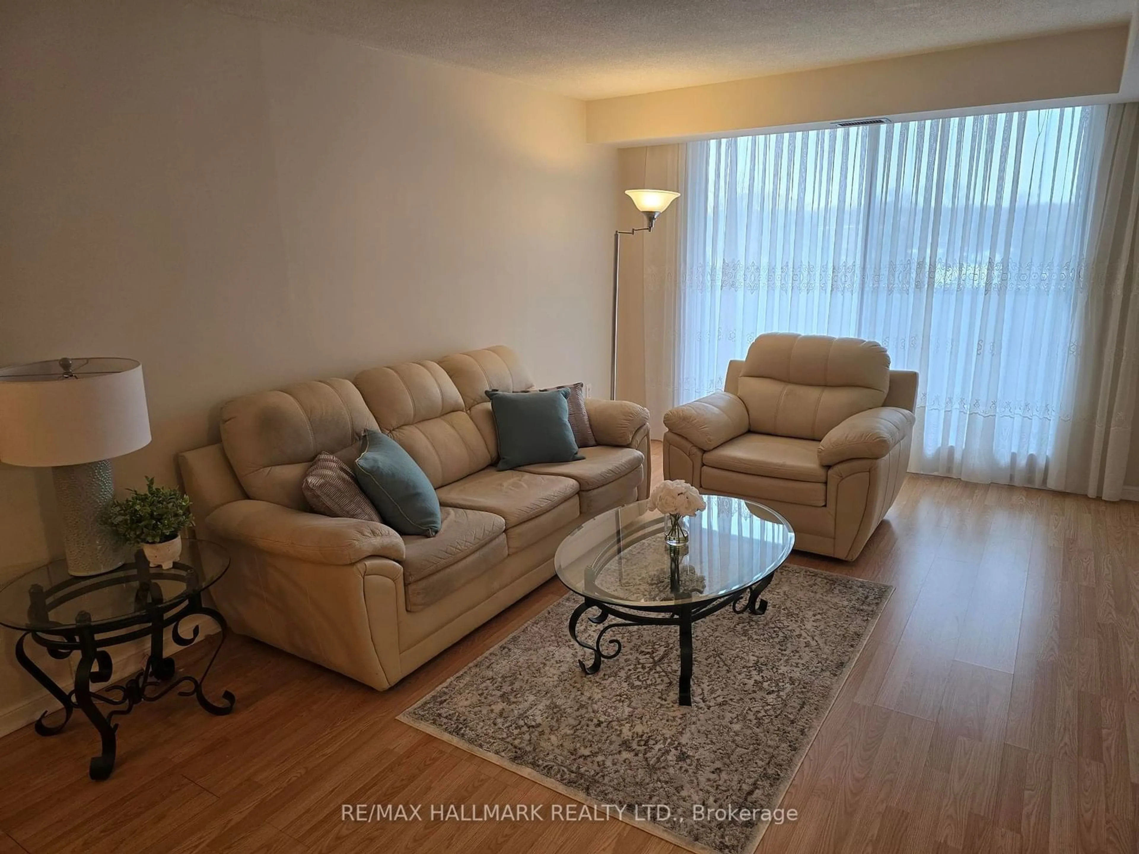 Living room with furniture, wood/laminate floor for 757 Victoria Park Ave #607, Toronto Ontario M4C 5N8