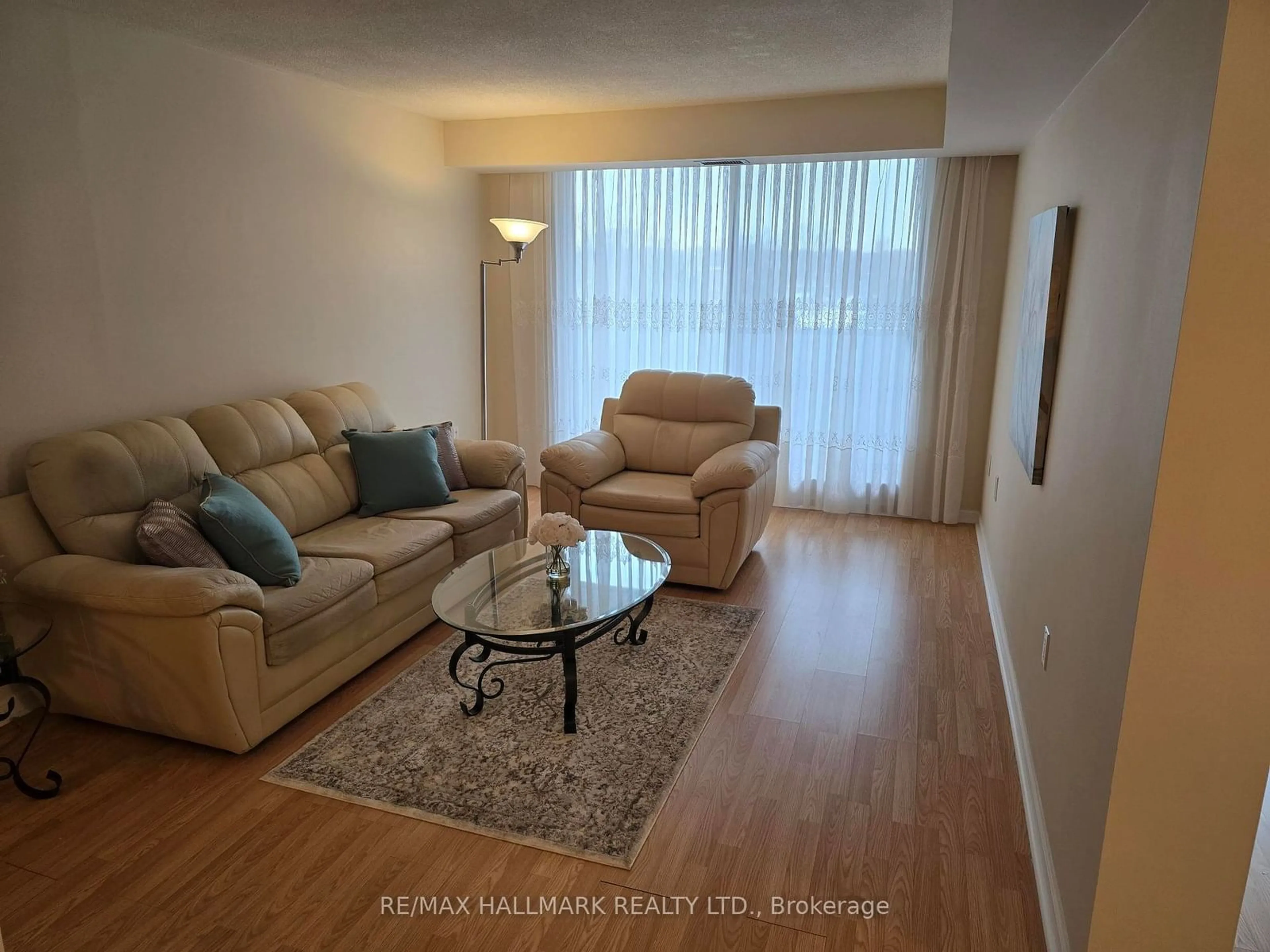 Living room with furniture, wood/laminate floor for 757 Victoria Park Ave #607, Toronto Ontario M4C 5N8