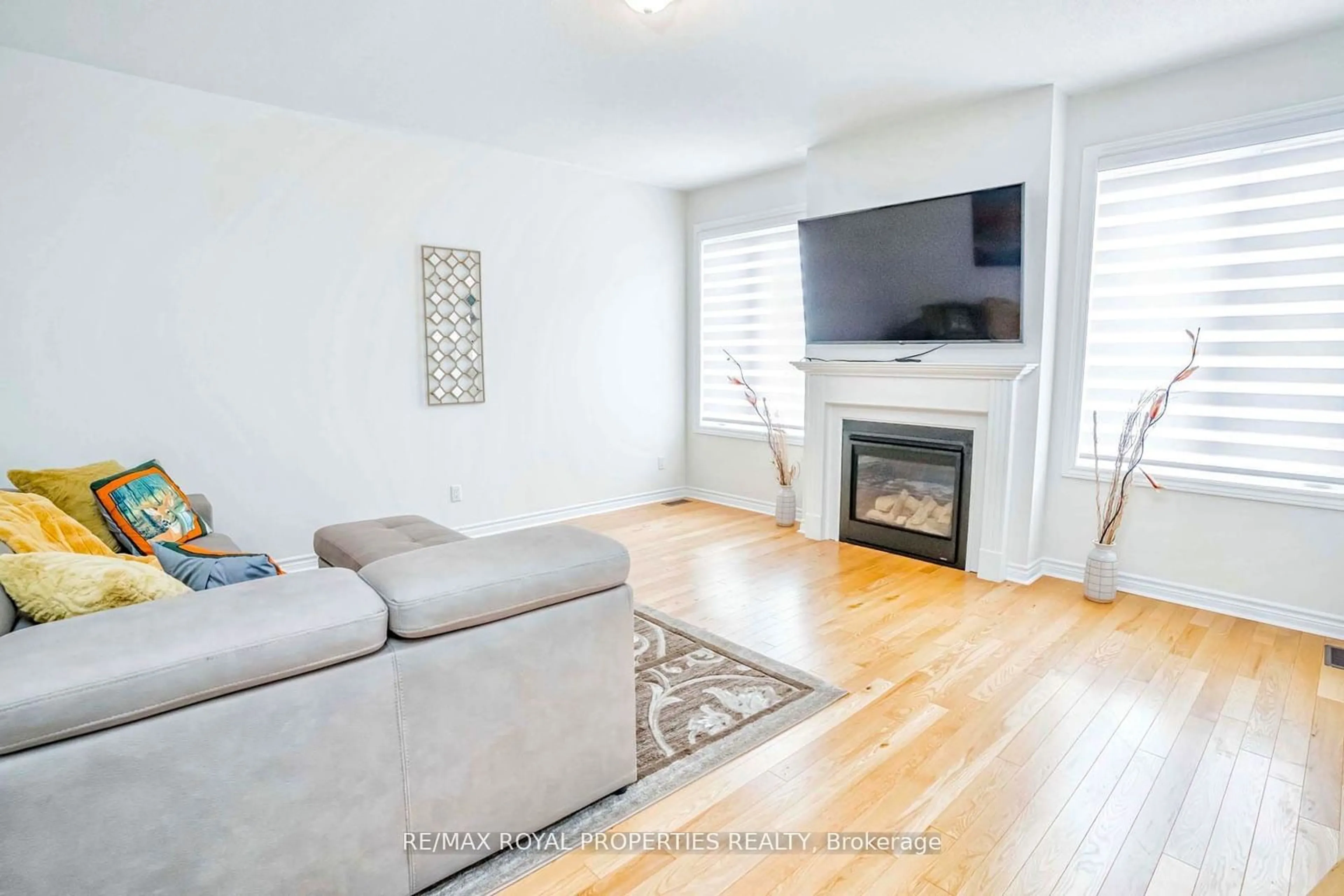 Living room with furniture, wood/laminate floor for 1877 Castlepoint Dr, Oshawa Ontario L1K 0M9