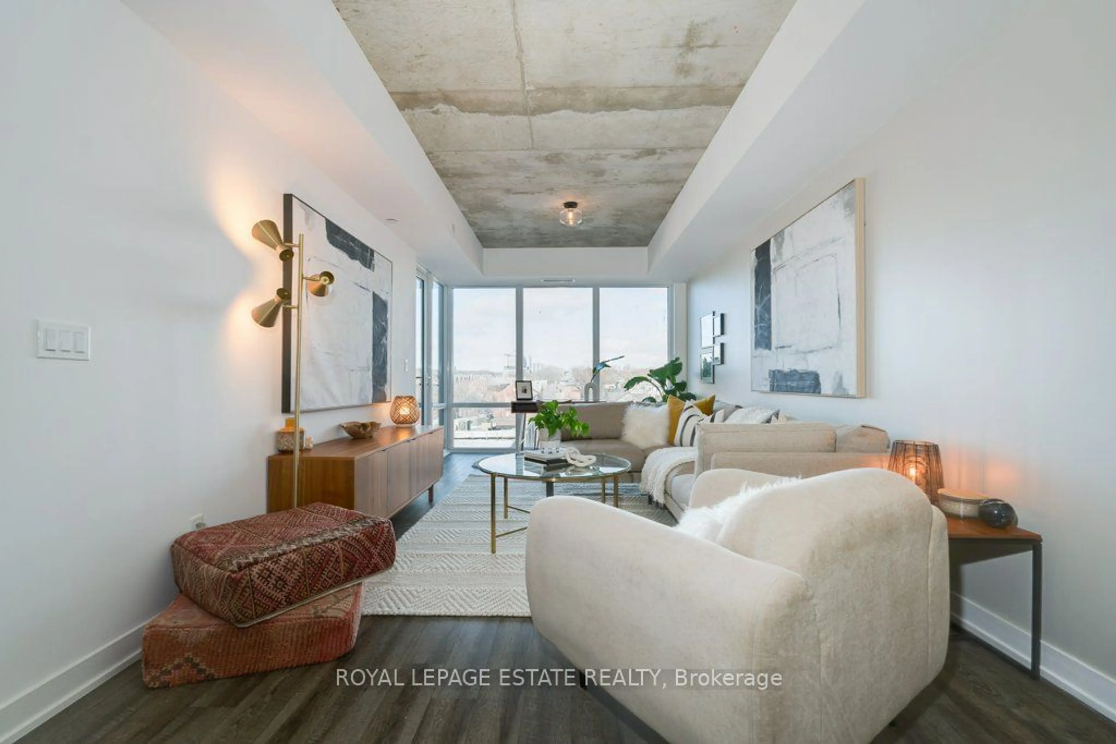 Living room with furniture, cement floor for 665 Queen St #403, Toronto Ontario M4M 0G3