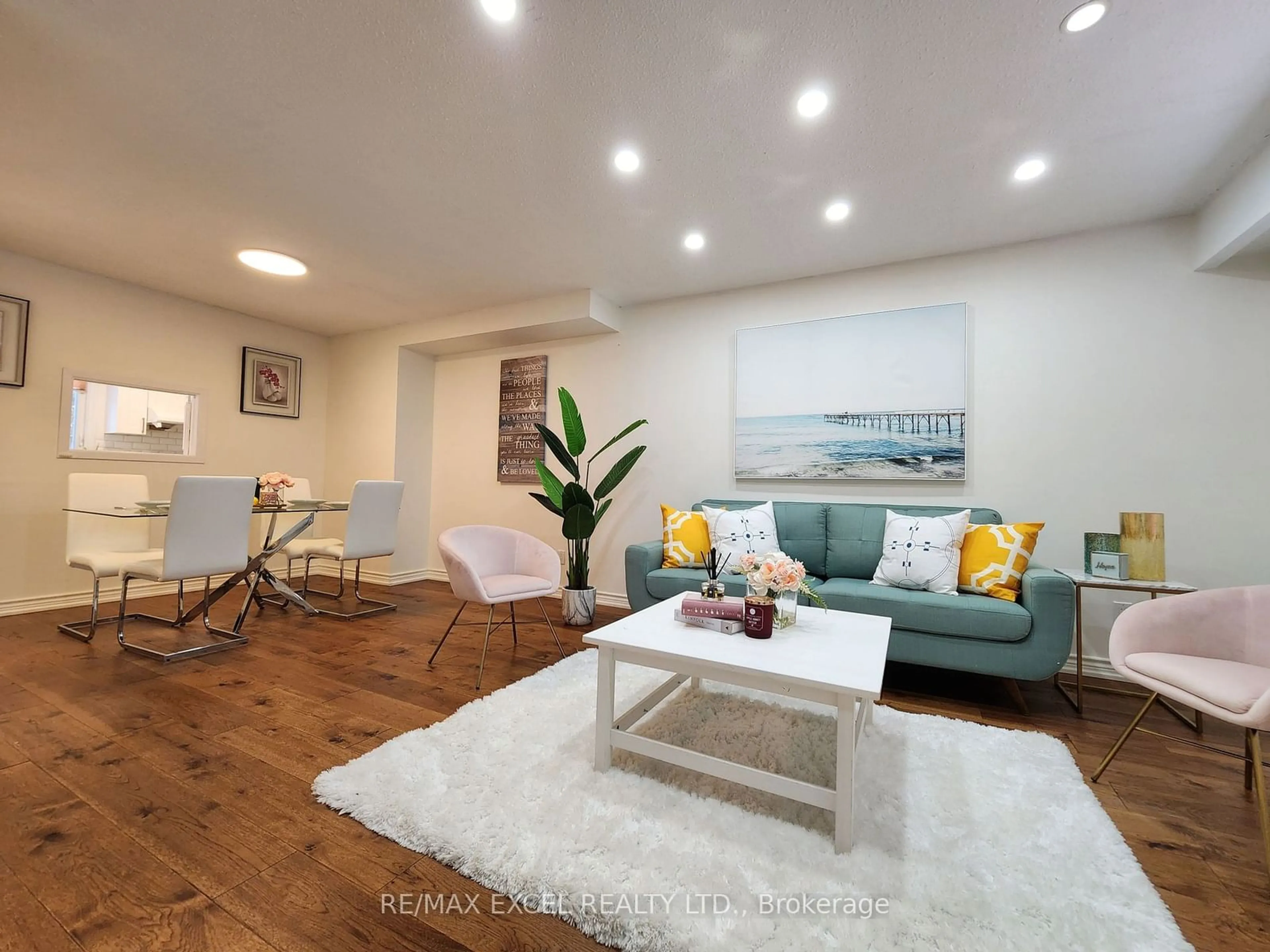 Living room with furniture, wood/laminate floor for 103 Fawndale Cres, Toronto Ontario M1W 2X3