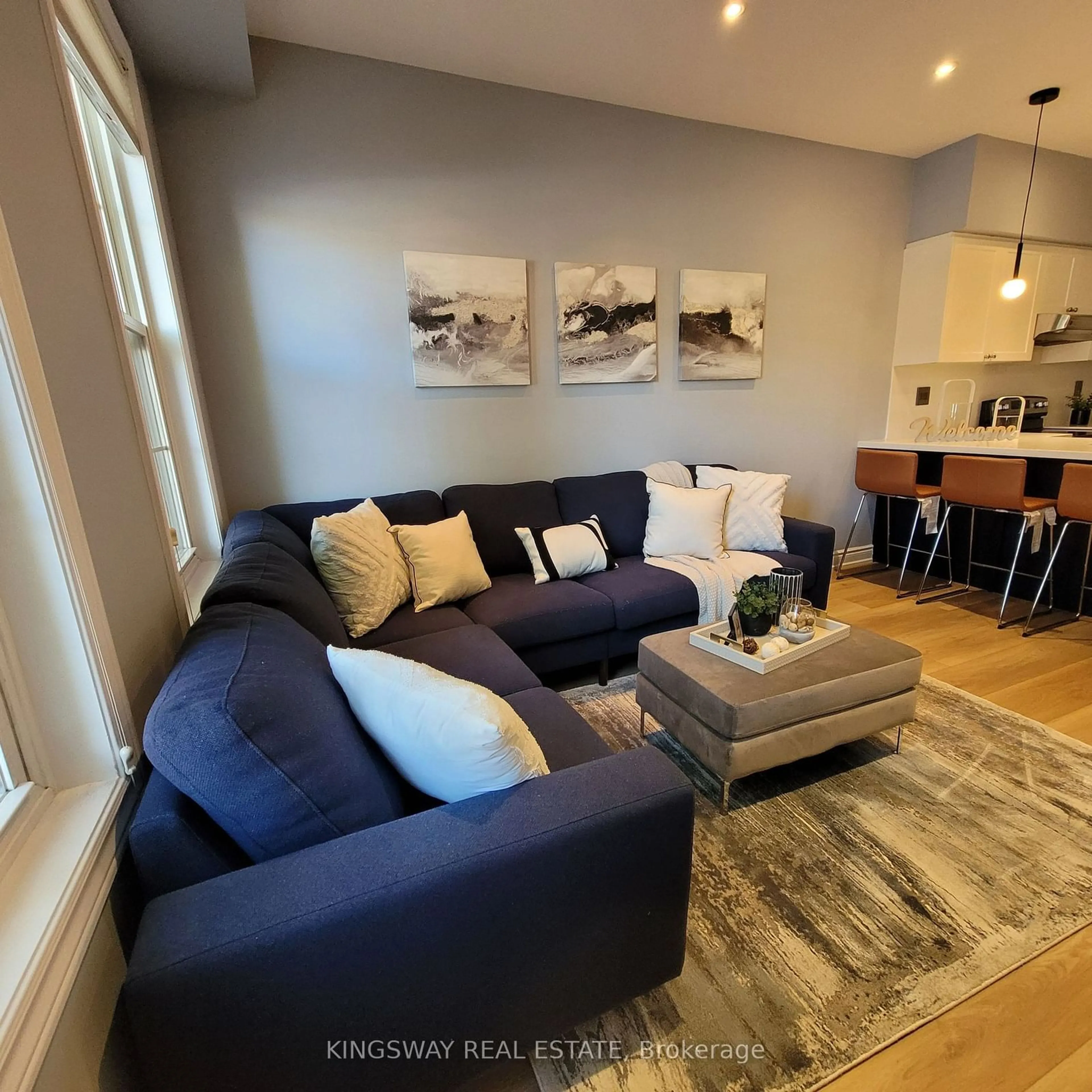 Living room with furniture, wood/laminate floor for 74B Coxwell Ave, Toronto Ontario M4L 3A7