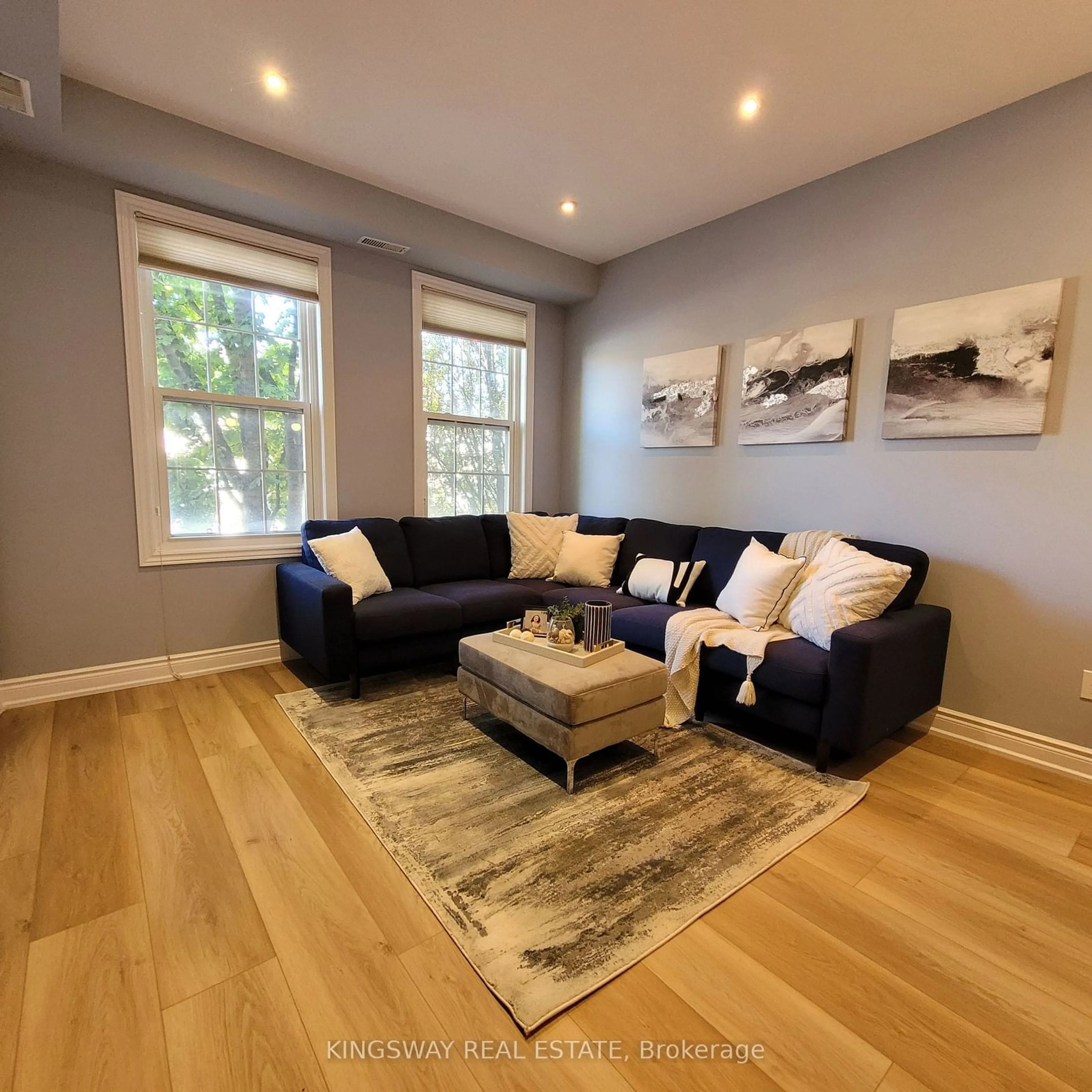 Living room with furniture, wood/laminate floor for 74B Coxwell Ave, Toronto Ontario M4L 3A7