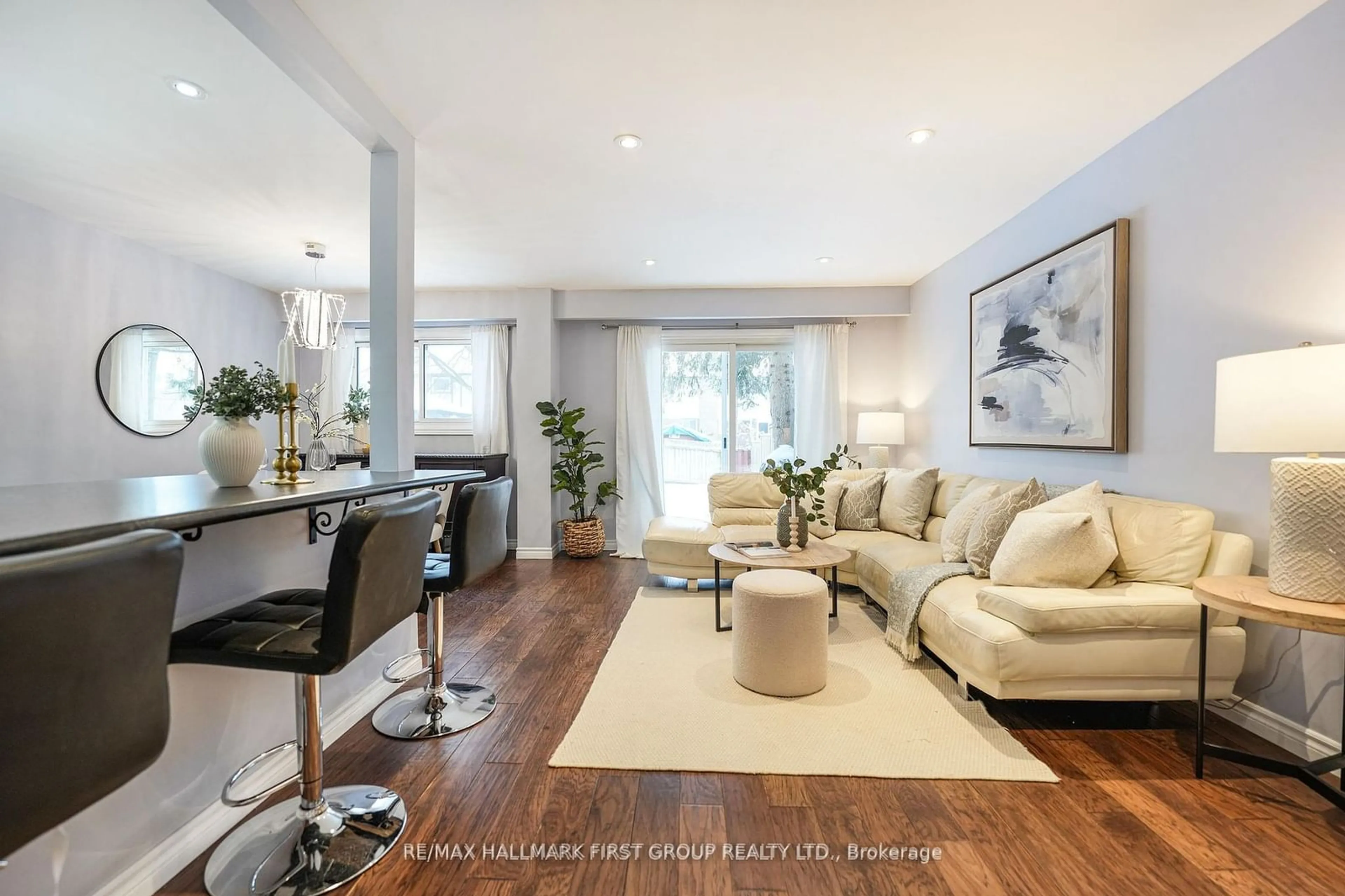 Living room with furniture, wood/laminate floor for 566 Berwick Cres, Oshawa Ontario L1J 3E7