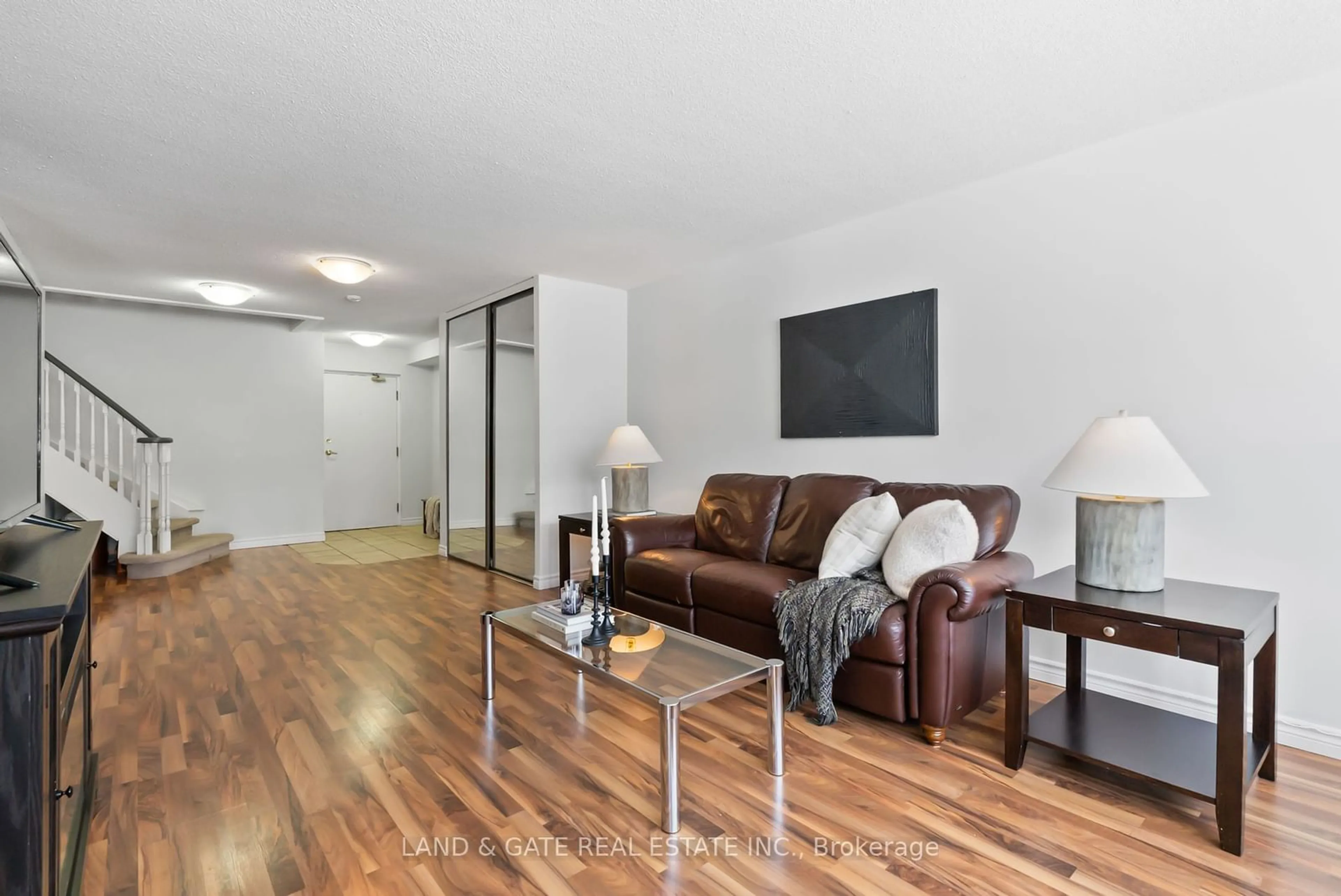 Living room with furniture, wood/laminate floor for 25 Cumberland Lane #112, Ajax Ontario L1S 7K1