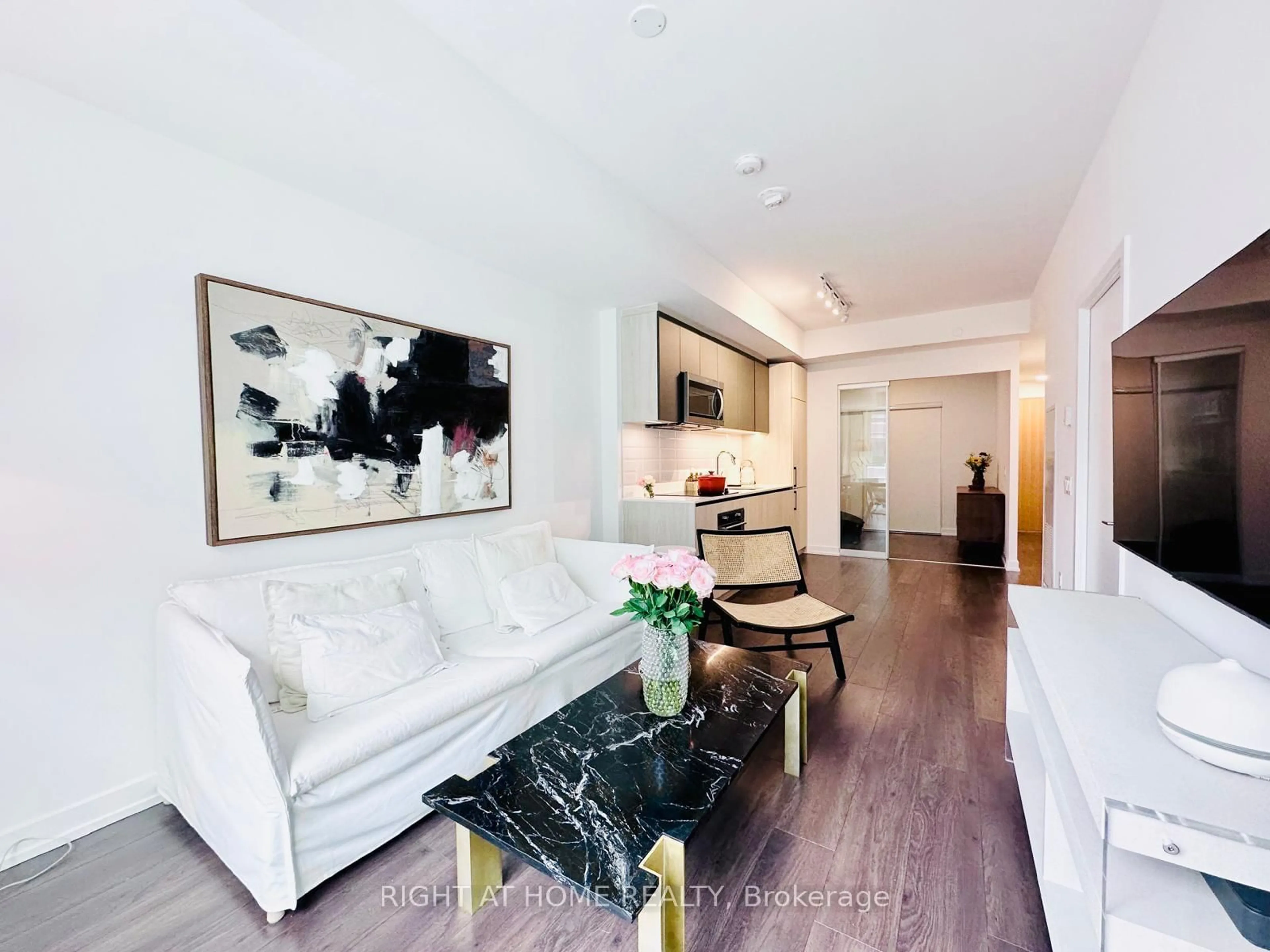 Living room with furniture, wood/laminate floor for 150 Logan Ave #225, Toronto Ontario M4M 0E4