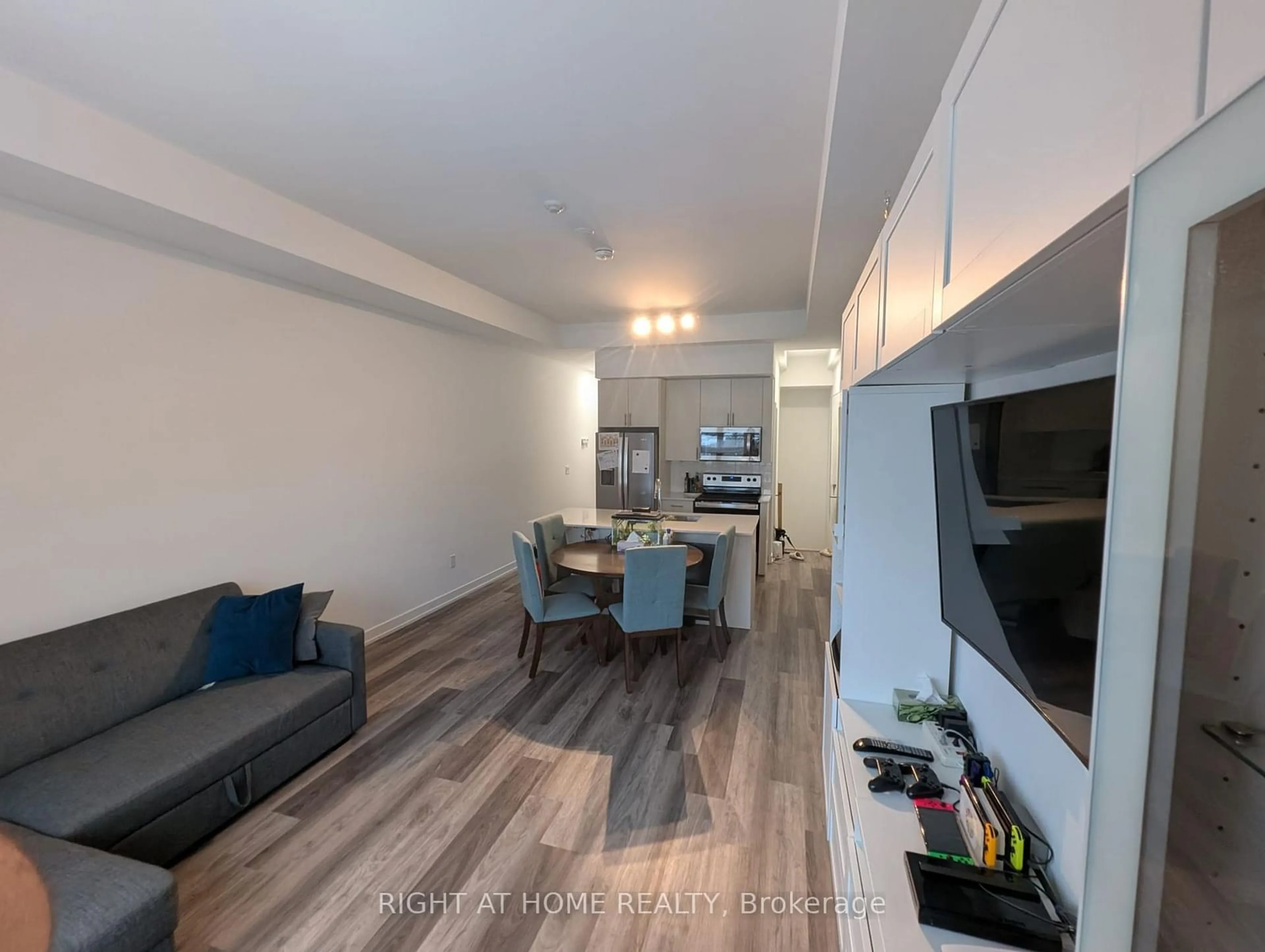 Living room with furniture, wood/laminate floor for 3686 St Clair Ave #112, Toronto Ontario M1M 1T2