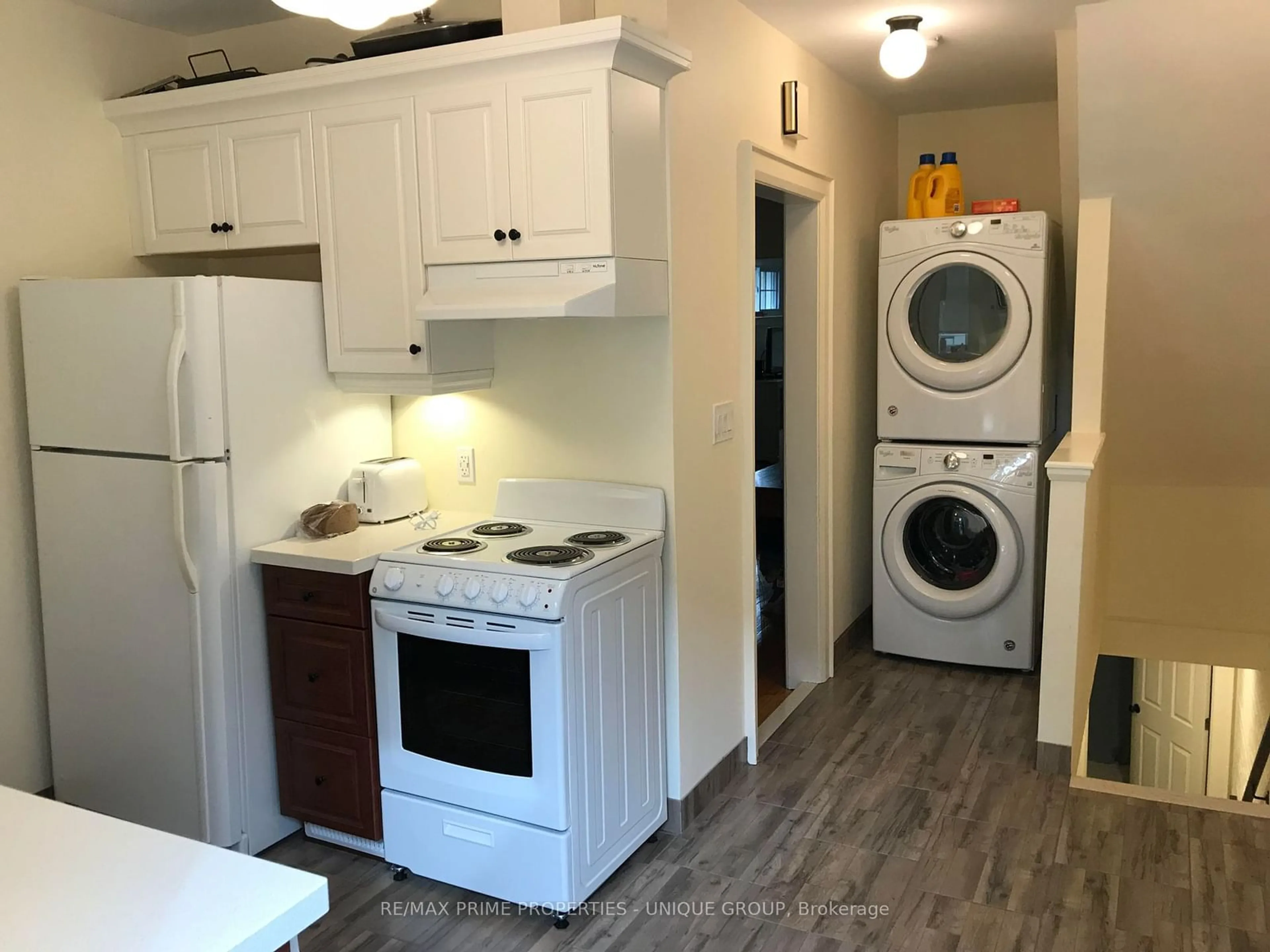 Kitchen with laundary machines, wood/laminate floor for 32 Woodington Ave, Toronto Ontario M4C 3J3