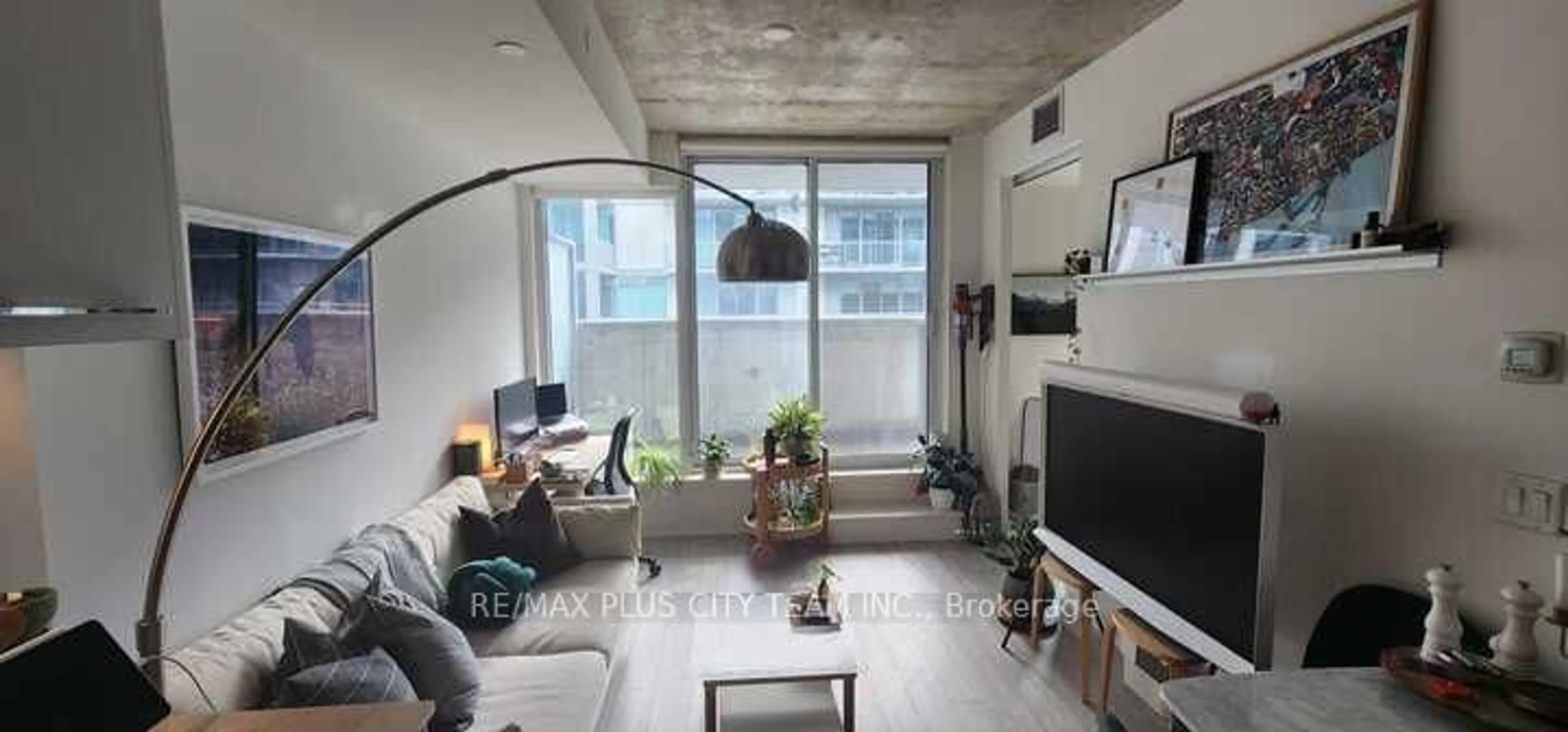 Living room with furniture, cement floor for 30 Baseball Pl #810, Toronto Ontario M4M 0E8