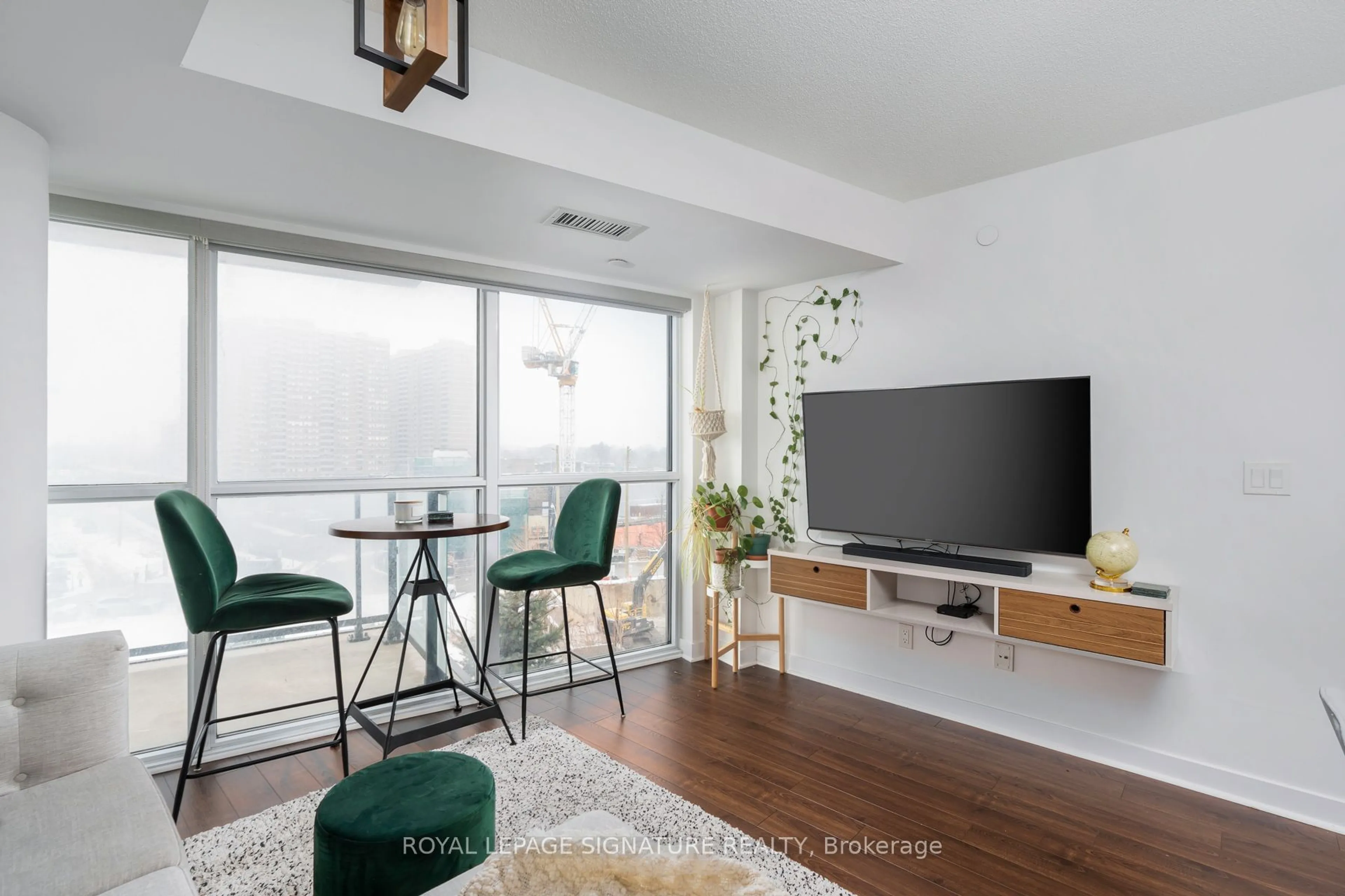 Living room with furniture, wood/laminate floor for 8 Trent Ave #523, Toronto Ontario M4C 5C6