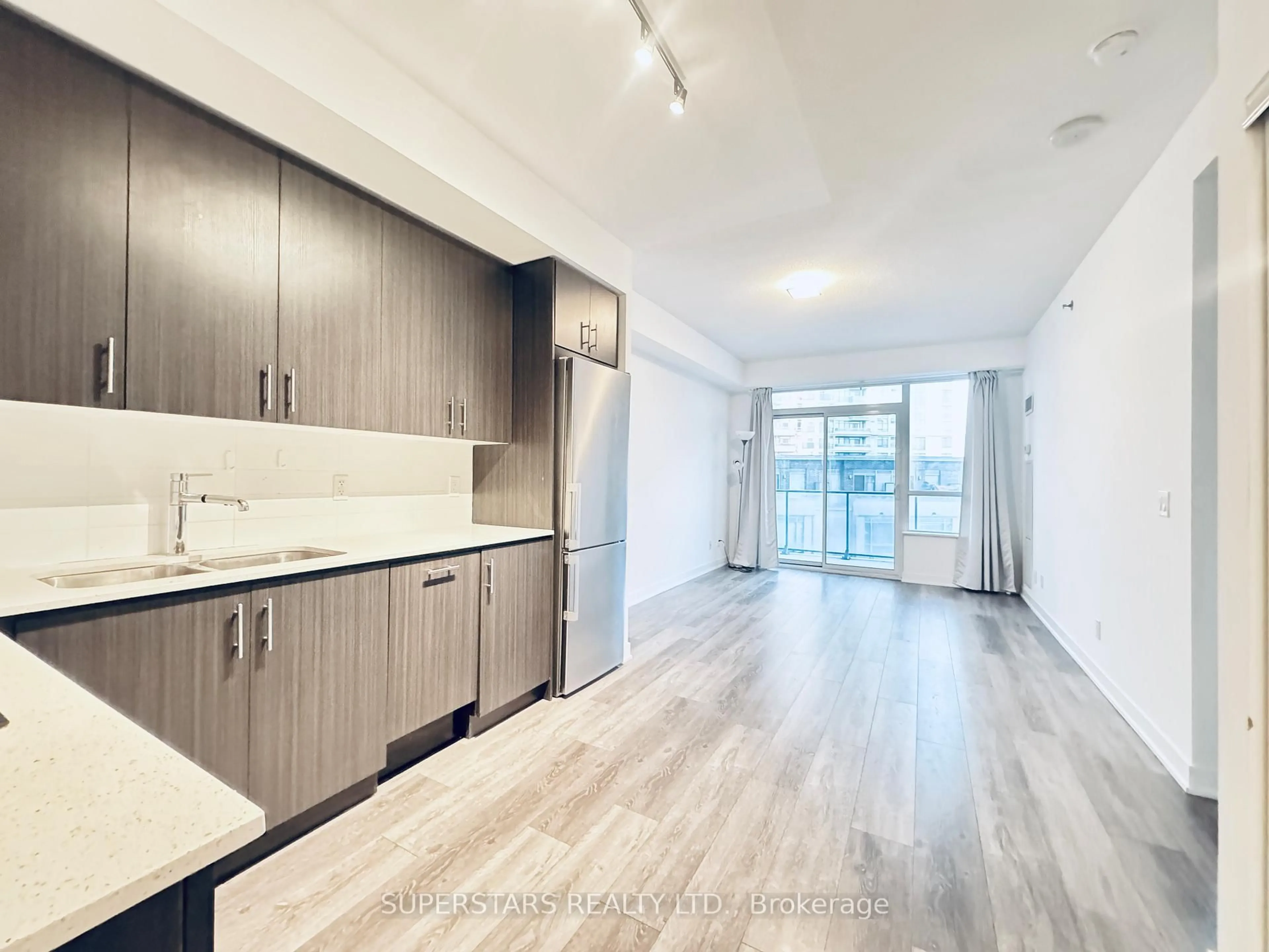 Open concept kitchen, wood/laminate floor for 195 Bonis Ave #308, Toronto Ontario M1T 0A5