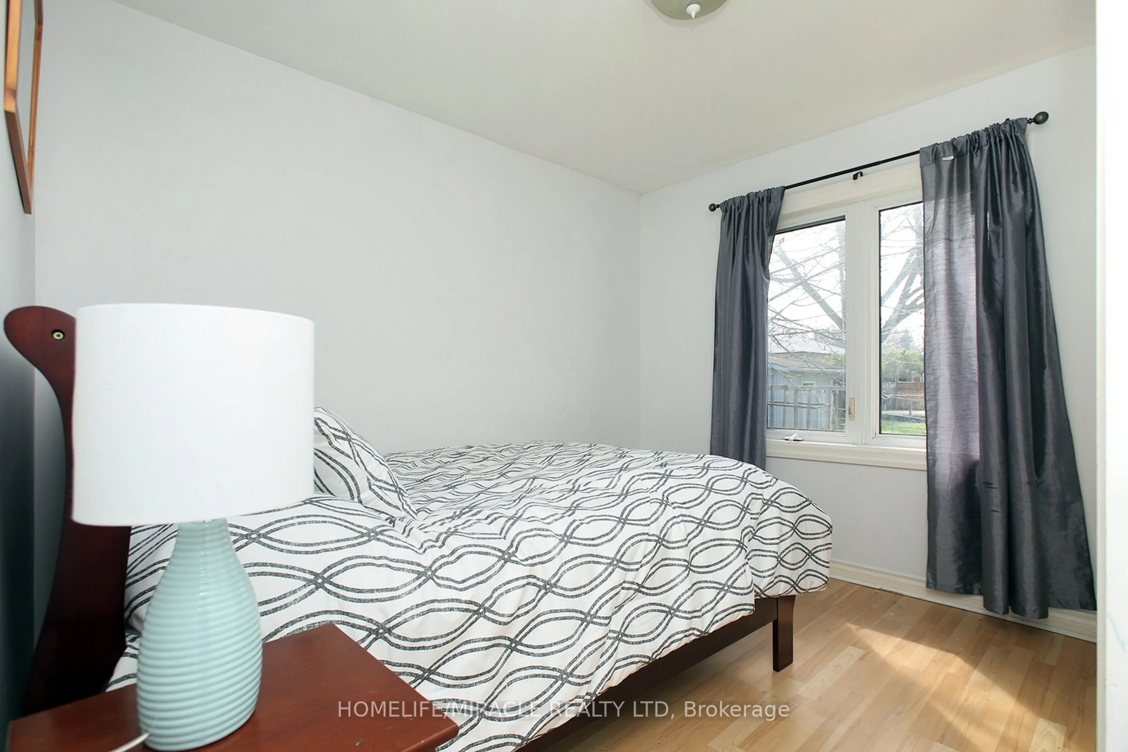 Bedroom with bed, wood/laminate floor for 23 Colonial Ave, Toronto Ontario M1M 2C3