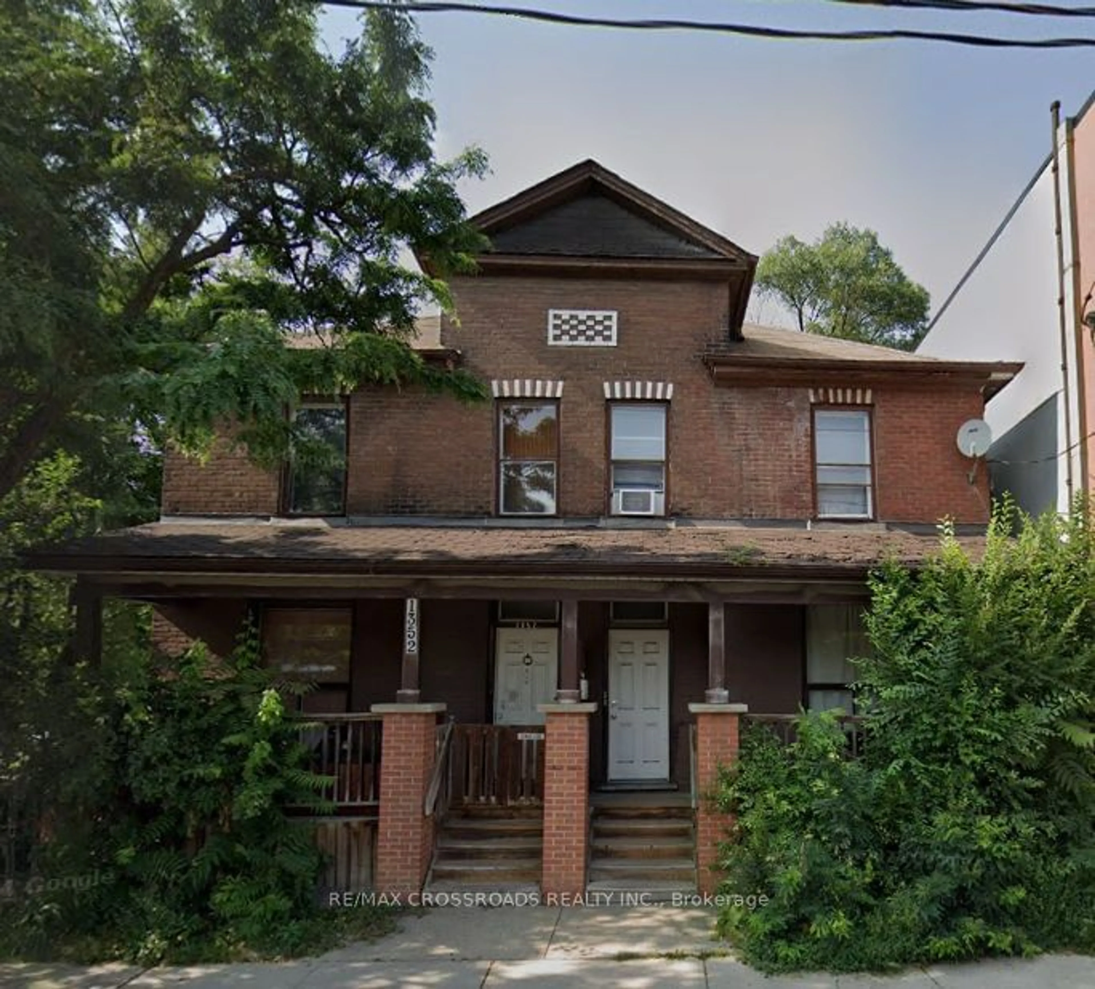 Home with brick exterior material, building for 1352-1354 Queen St, Toronto Ontario M4L 1C8