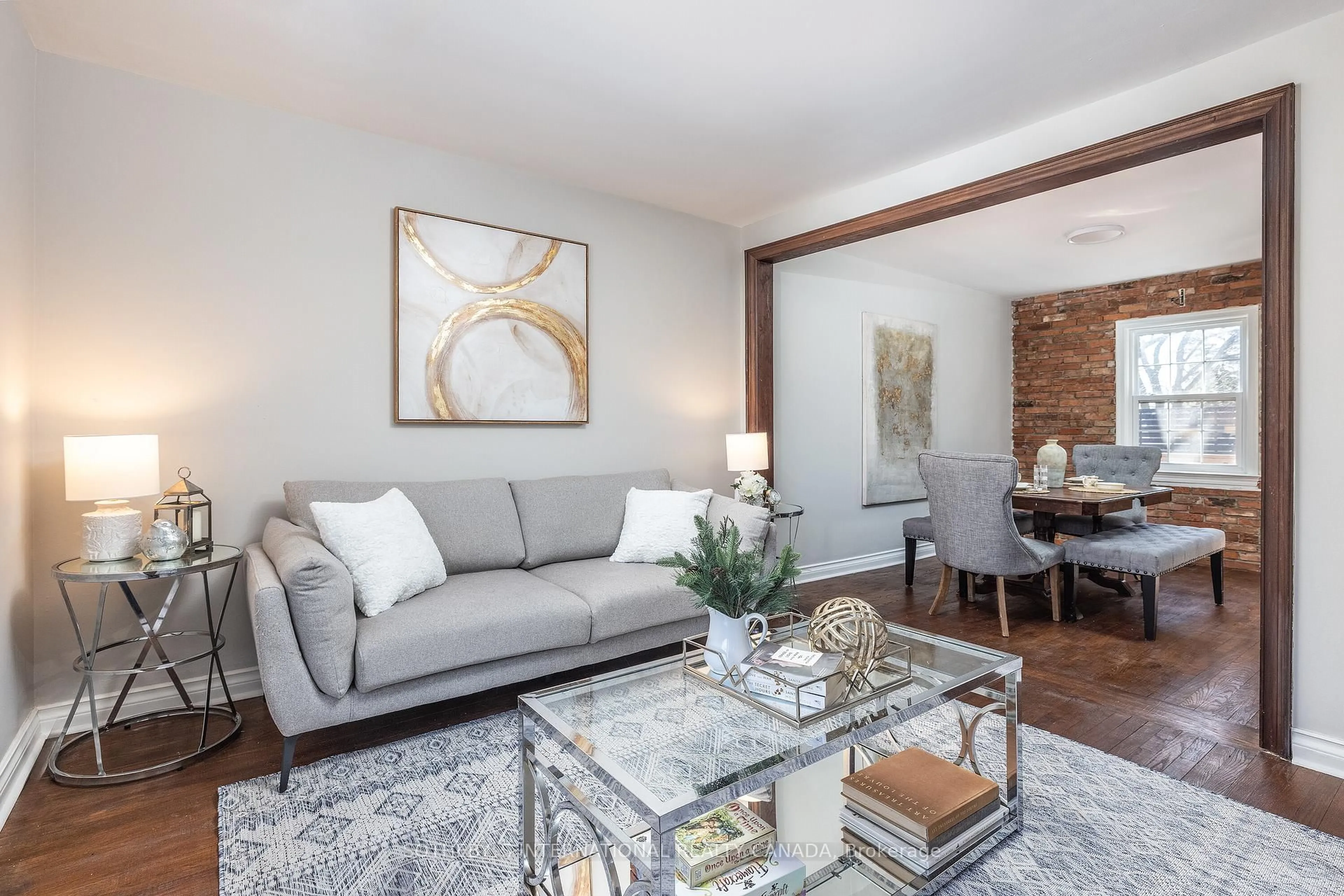 Living room with furniture, wood/laminate floor for 33 Southmead Rd, Toronto Ontario M1L 2H9