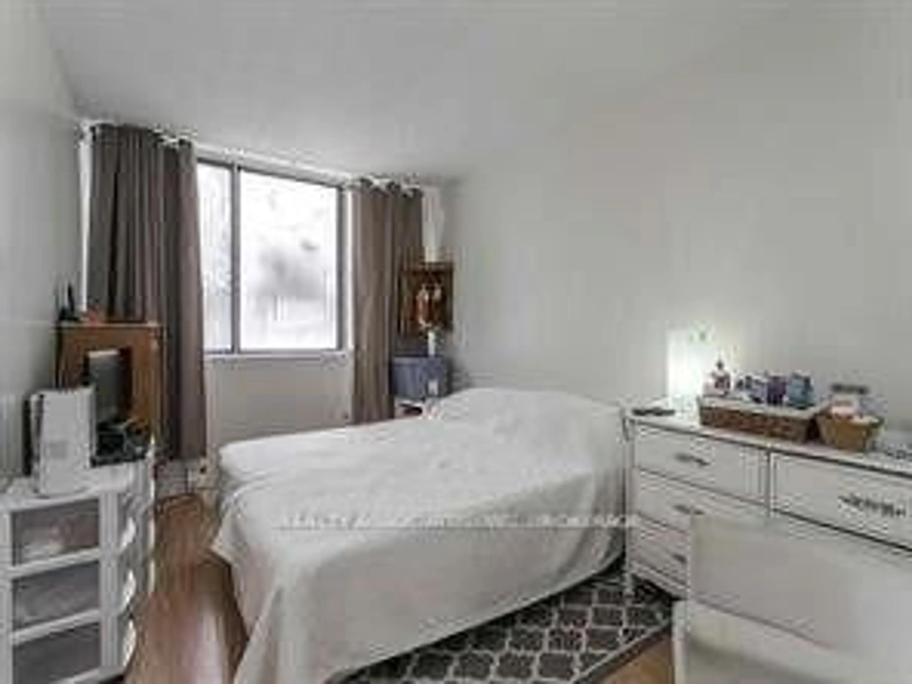 Bedroom with bed, wood/laminate floor for 2500 Bridletowne Circ #107, Toronto Ontario M1W 2V6