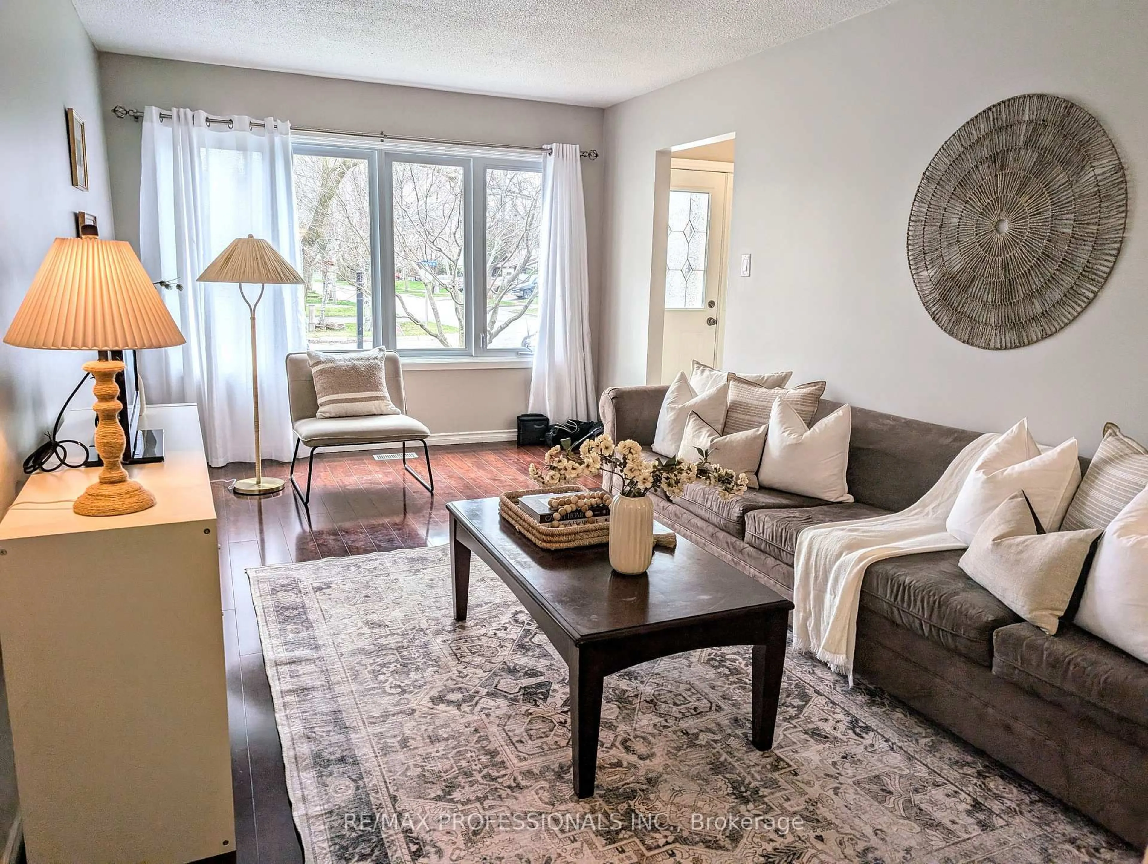 Living room with furniture, wood/laminate floor for 240 Limerick St, Oshawa Ontario L1J 6K9