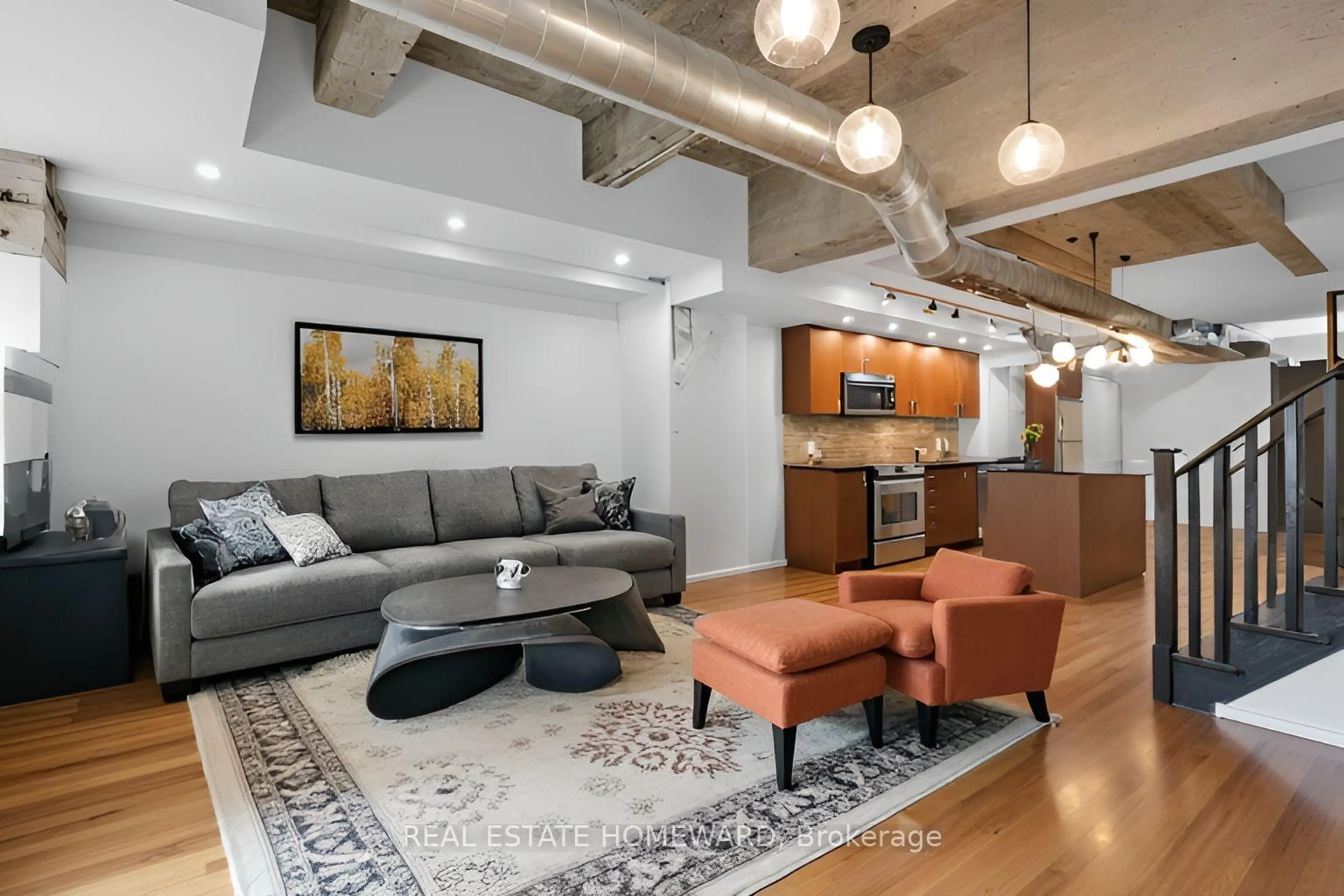 Living room with furniture, cement floor for 201 Carlaw Ave #128, Toronto Ontario M4M 2S3