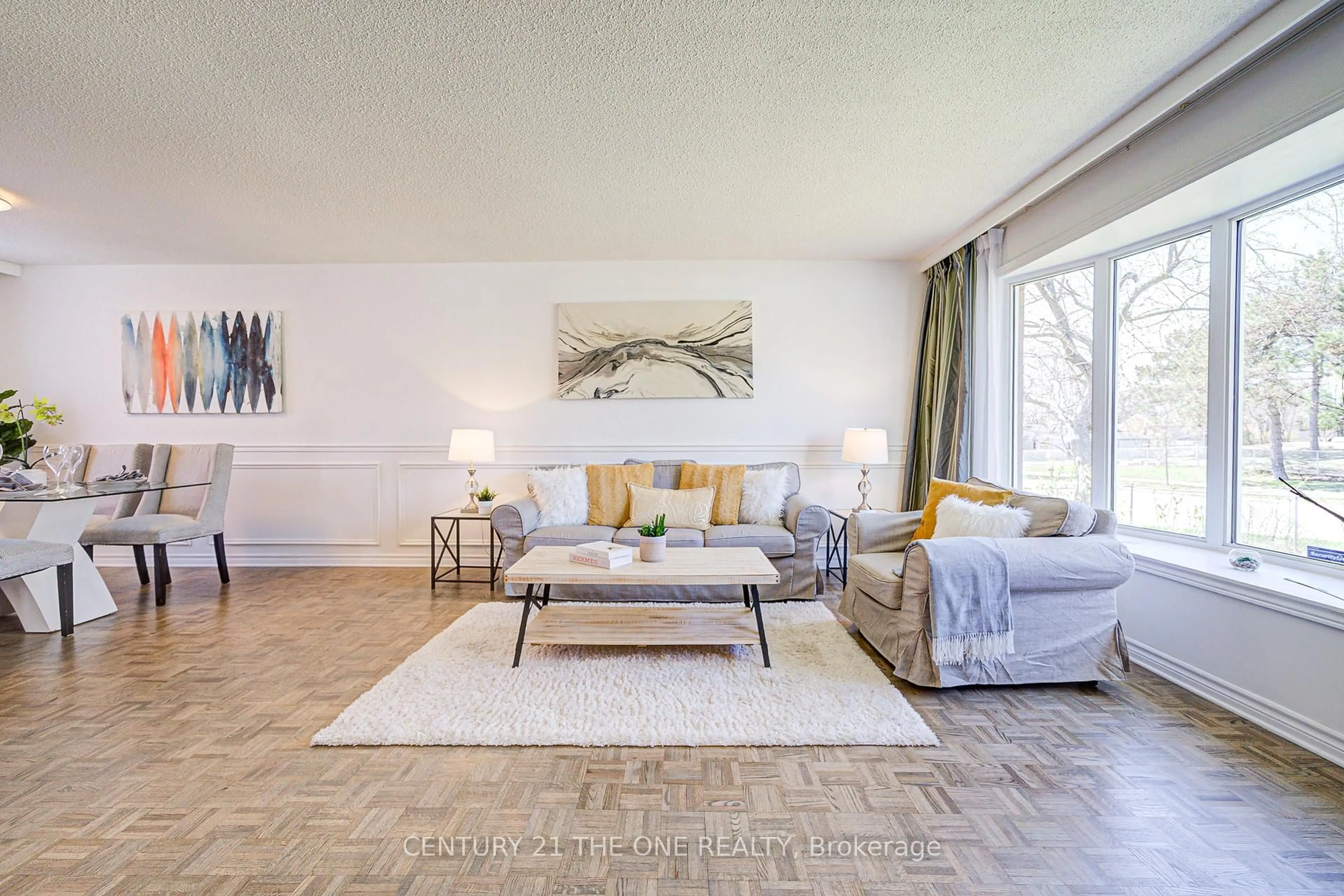Living room with furniture, wood/laminate floor for 119 Berner Tr, Toronto Ontario M1B 1B5