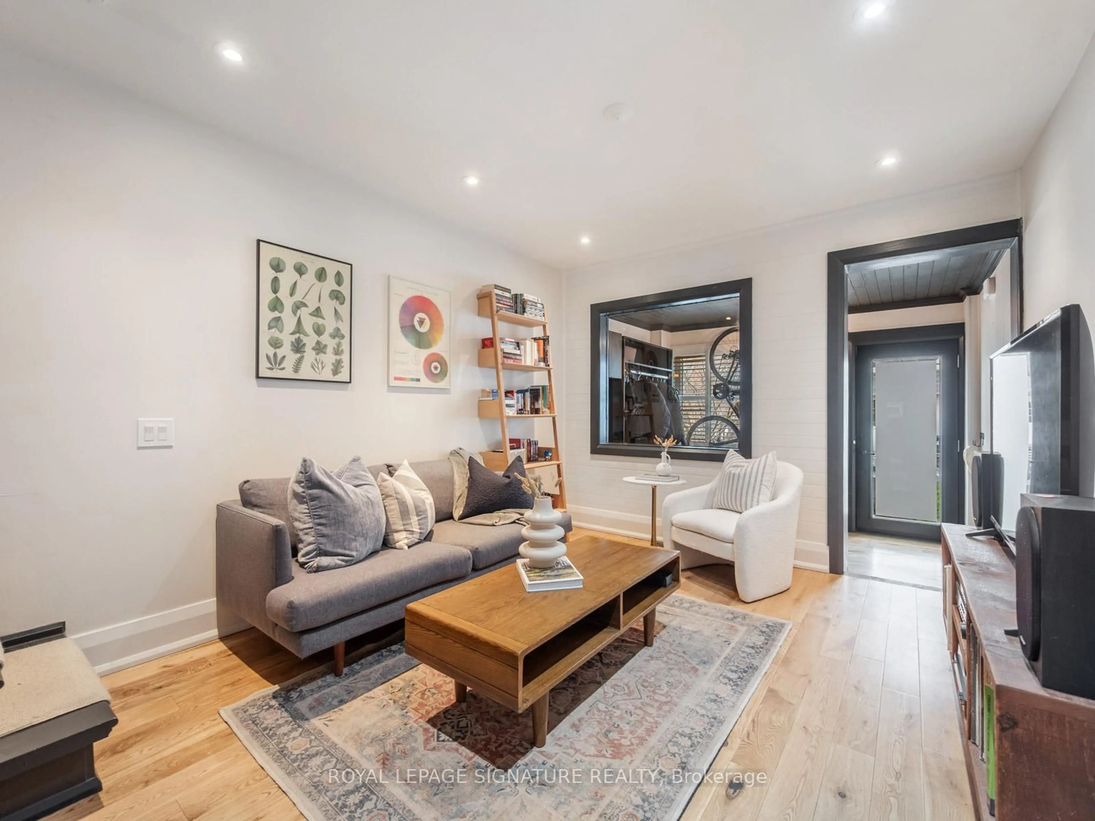Living room with furniture, wood/laminate floor for 288 Rhodes Ave, Toronto Ontario M4L 3A3