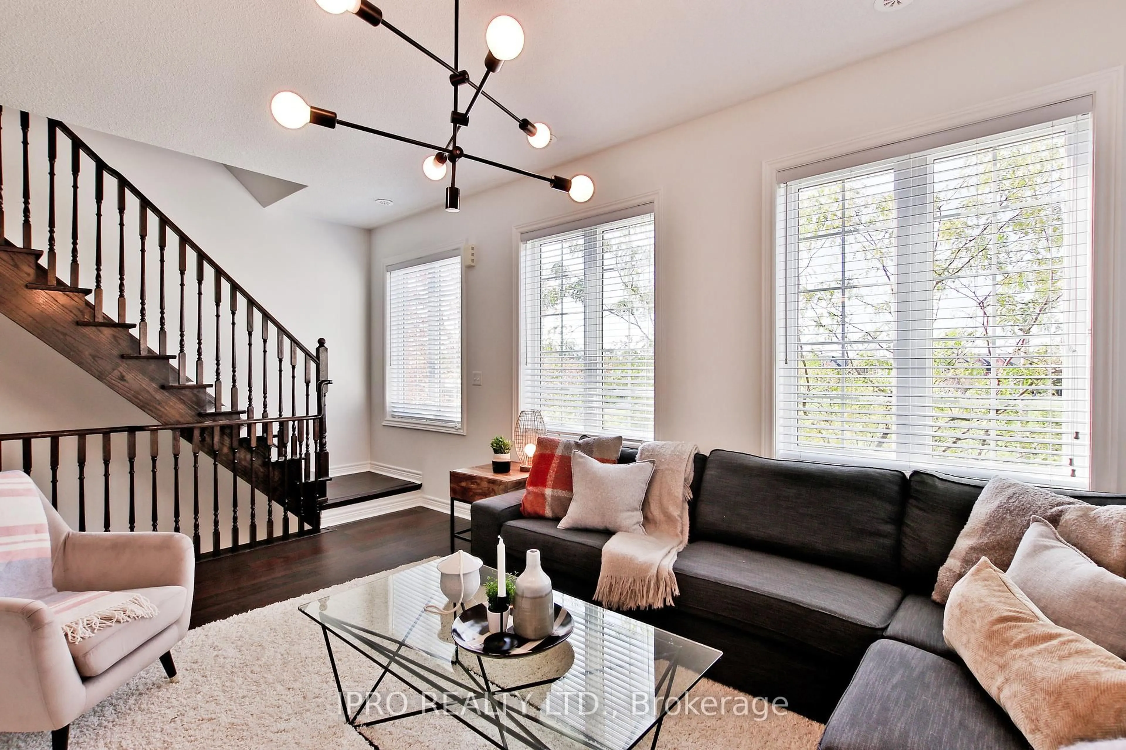 Living room with furniture, wood/laminate floor for 13 Brockville St, Toronto Ontario M4E 0A7
