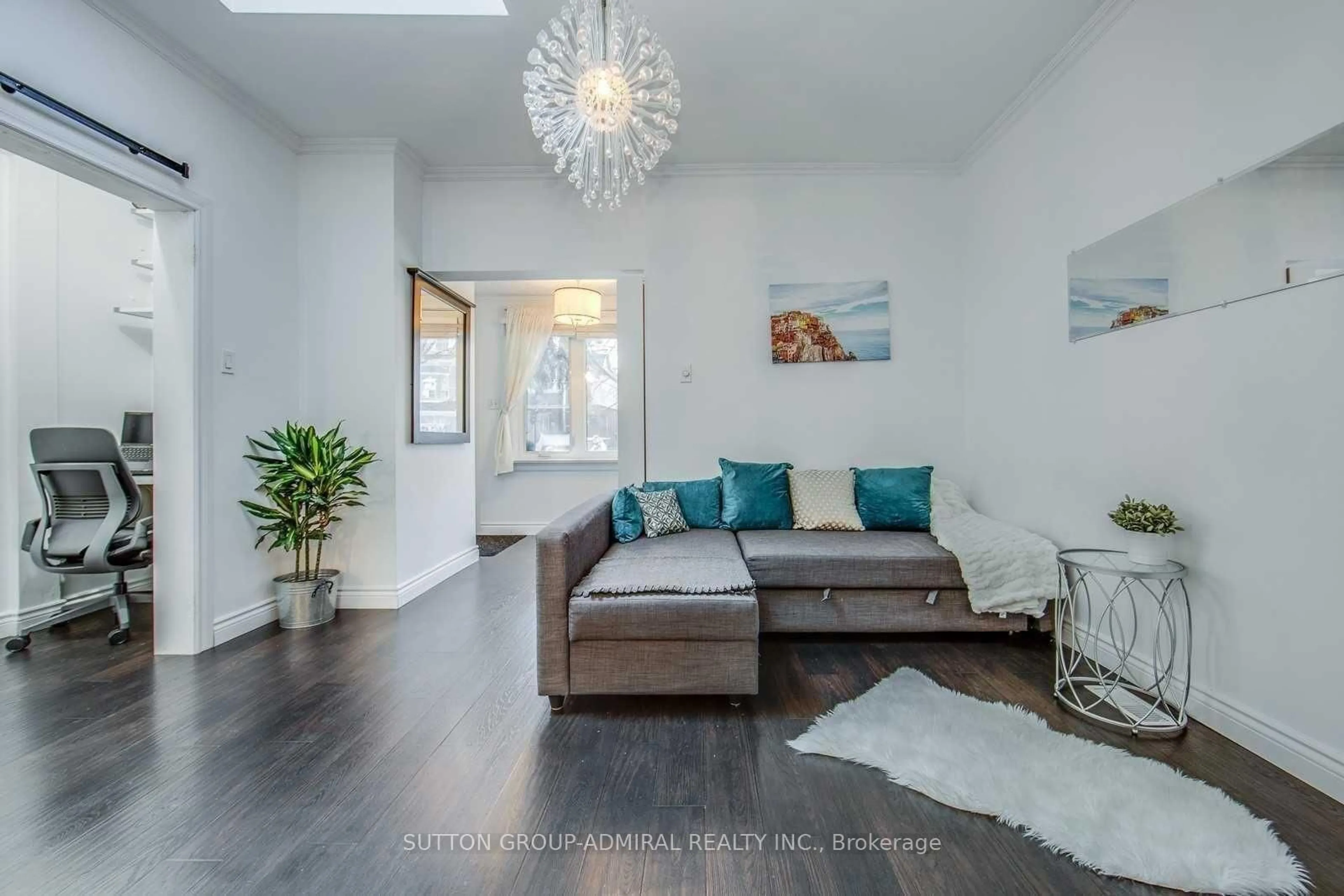 Living room with furniture, wood/laminate floor for 53 Rhodes Ave, Toronto Ontario M4L 2Z8