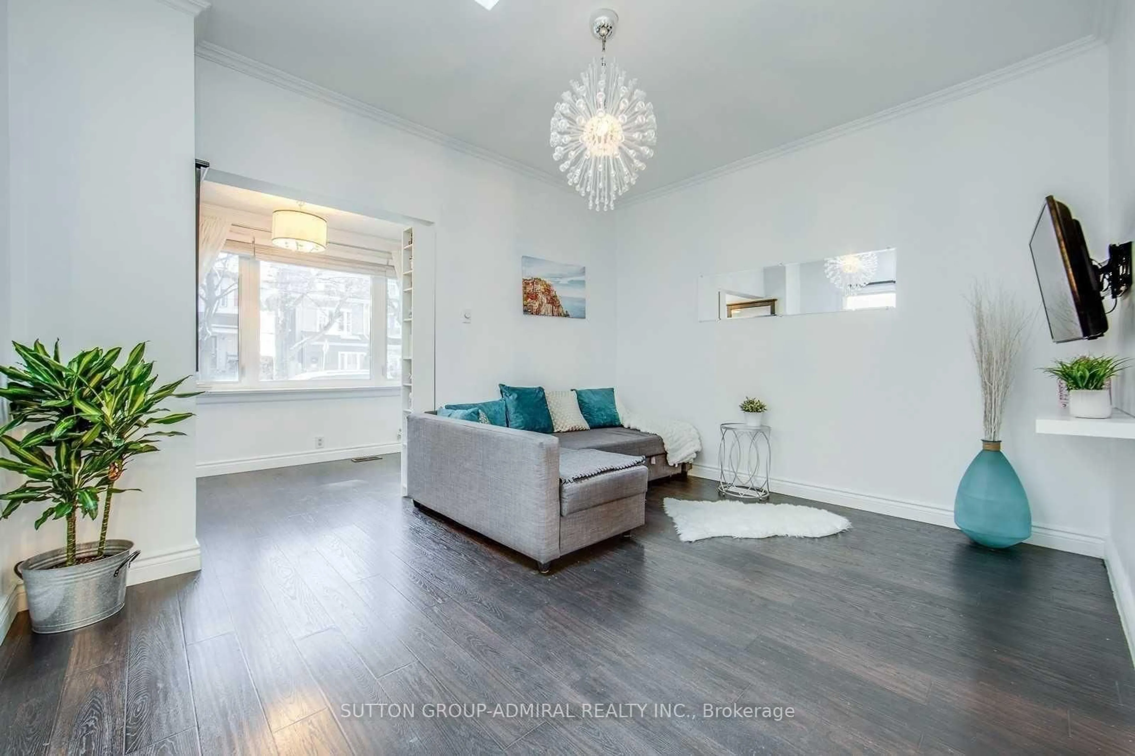 Living room with furniture, wood/laminate floor for 53 Rhodes Ave, Toronto Ontario M4L 2Z8