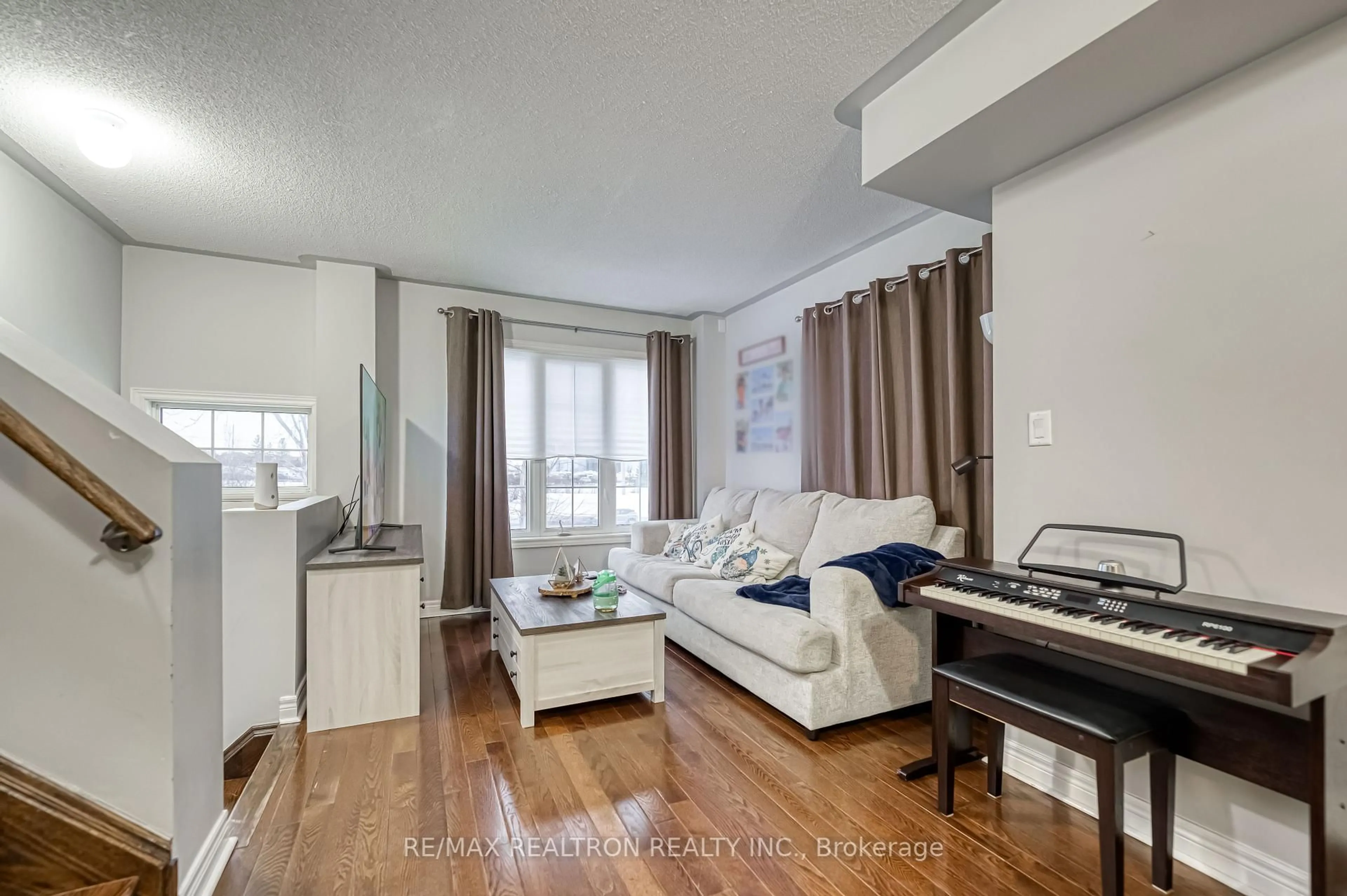 Living room with furniture, wood/laminate floor for 29 Cooperage Lane, Ajax Ontario L1S 0E8
