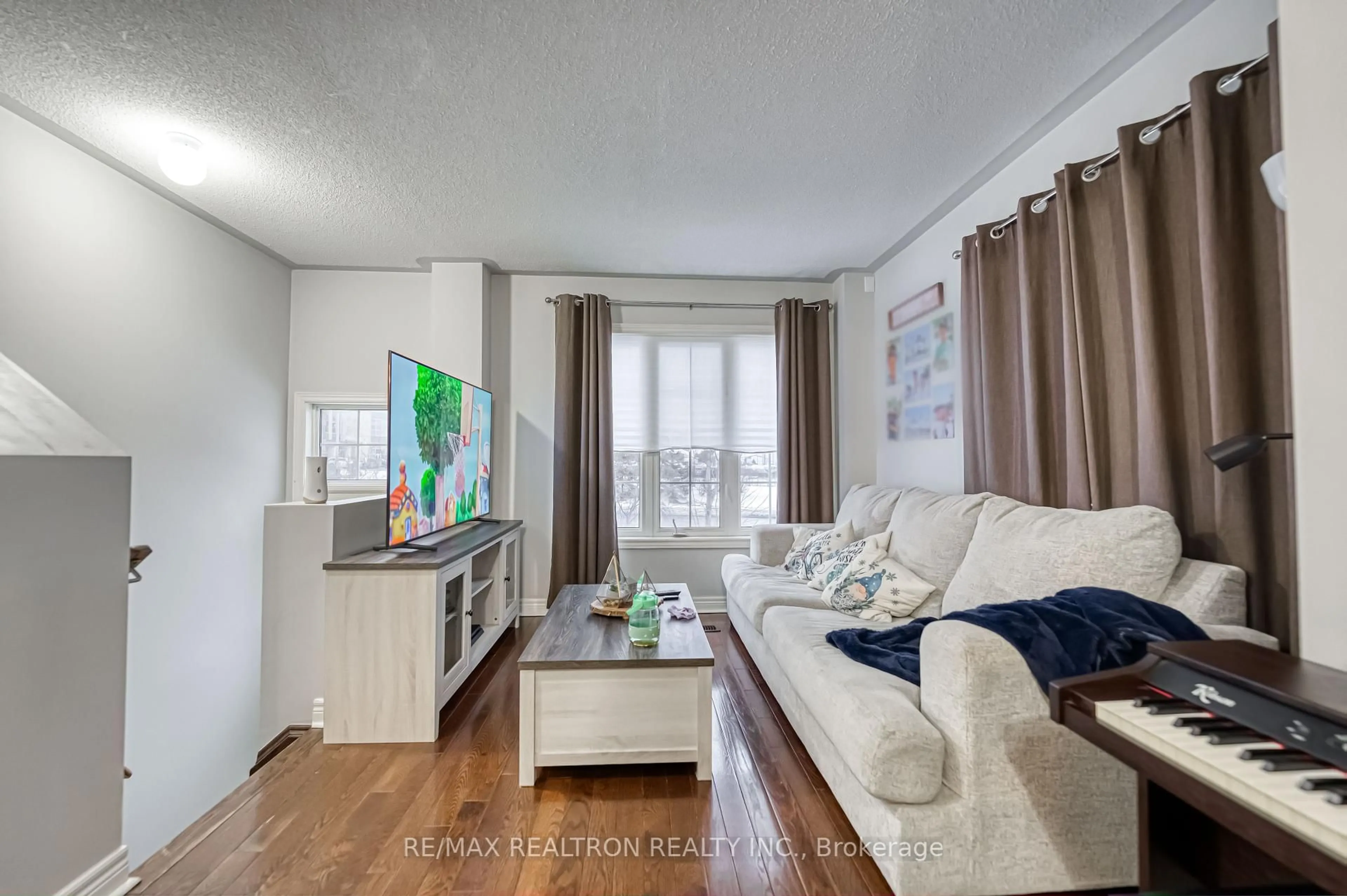 Living room with furniture, wood/laminate floor for 29 Cooperage Lane, Ajax Ontario L1S 0E8