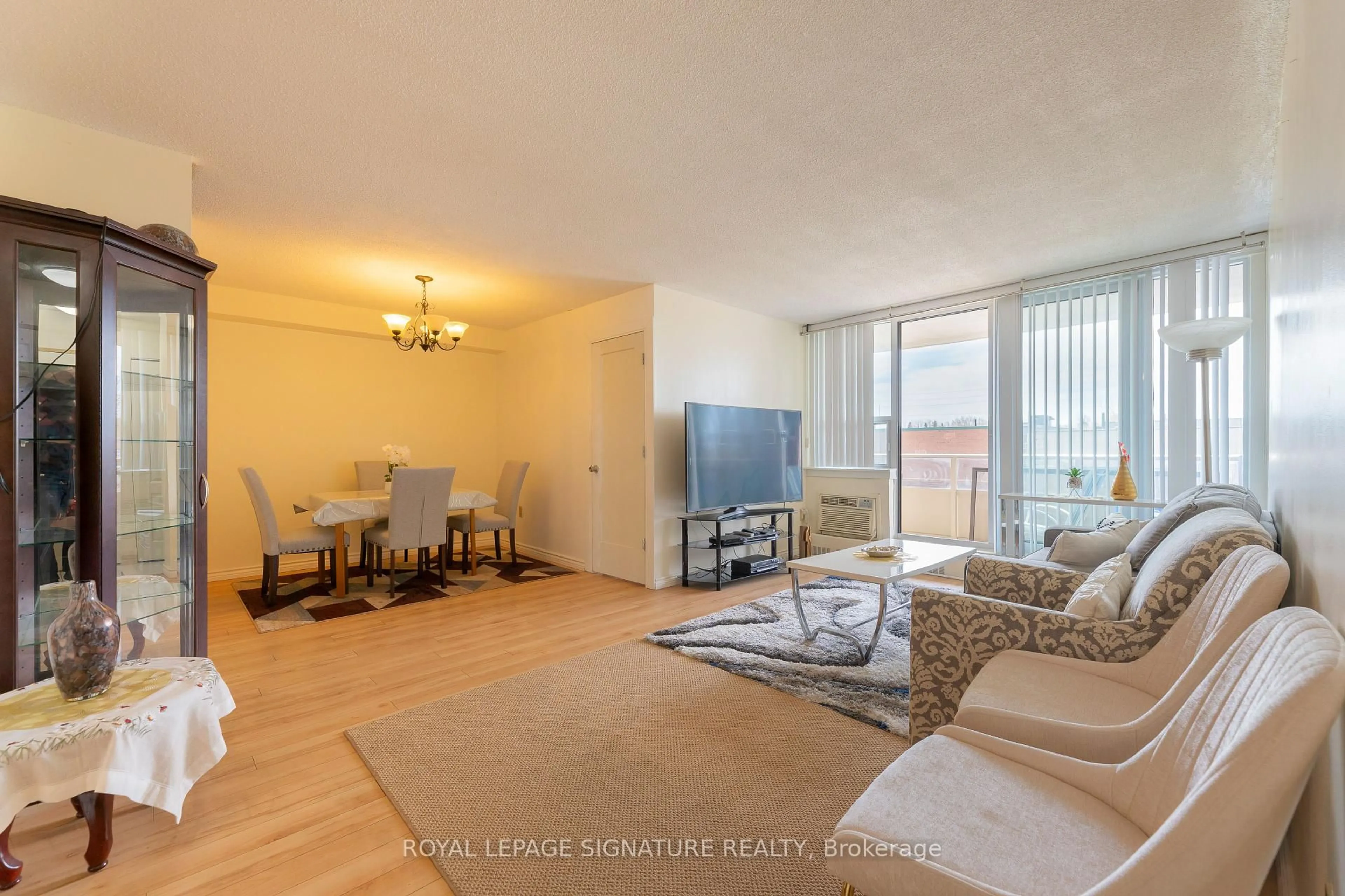 Living room with furniture, wood/laminate floor for 15 Torrance Rd #207, Toronto Ontario M1J 3K2