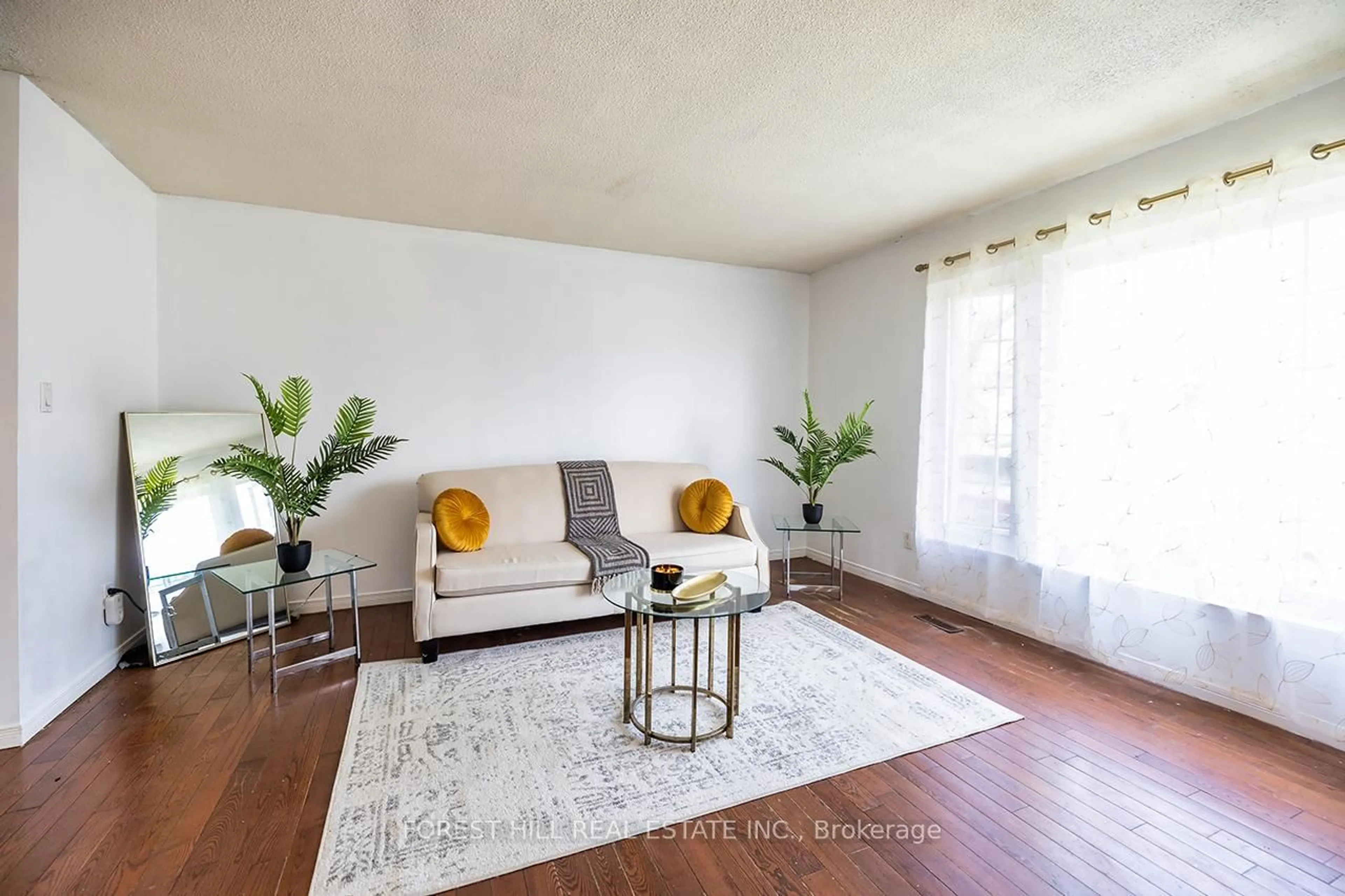 Living room with furniture, wood/laminate floor for 105 Parsell Sq, Toronto Ontario M1B 2A5
