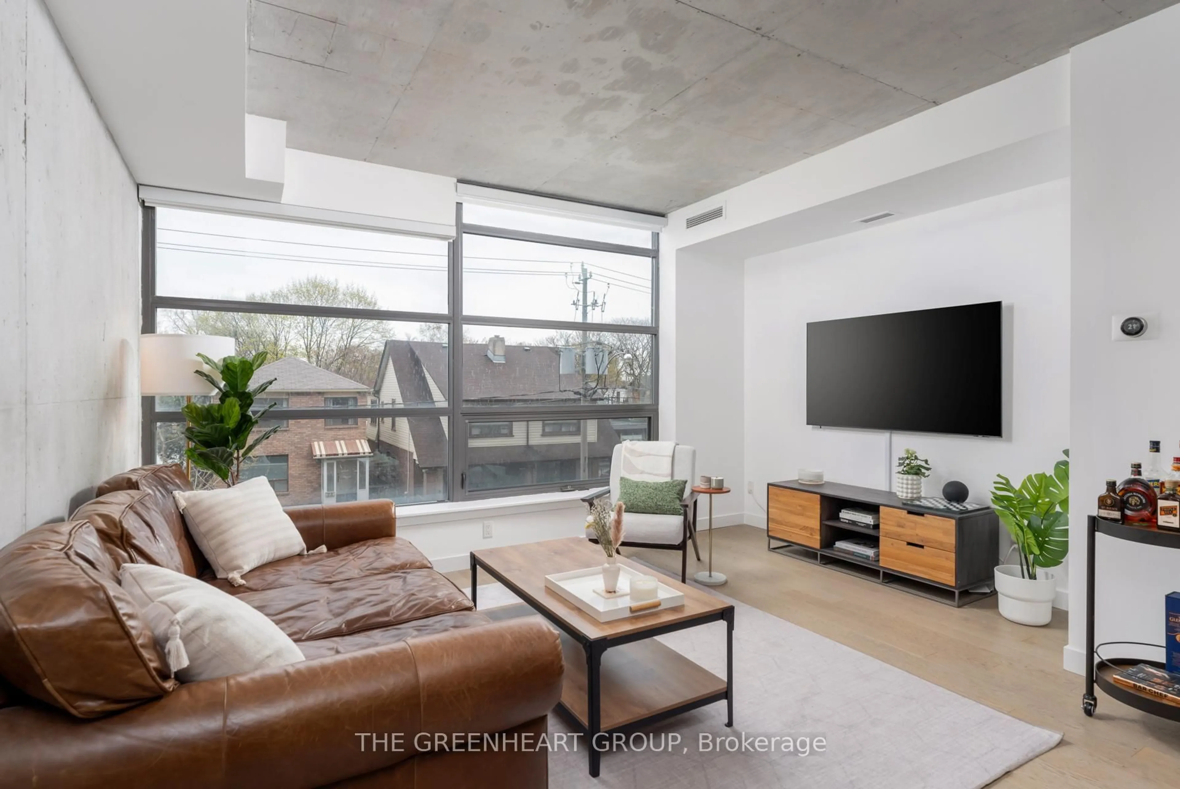 Living room with furniture, cement floor for 90 Broadview Ave #205, Toronto Ontario M4M 0A7