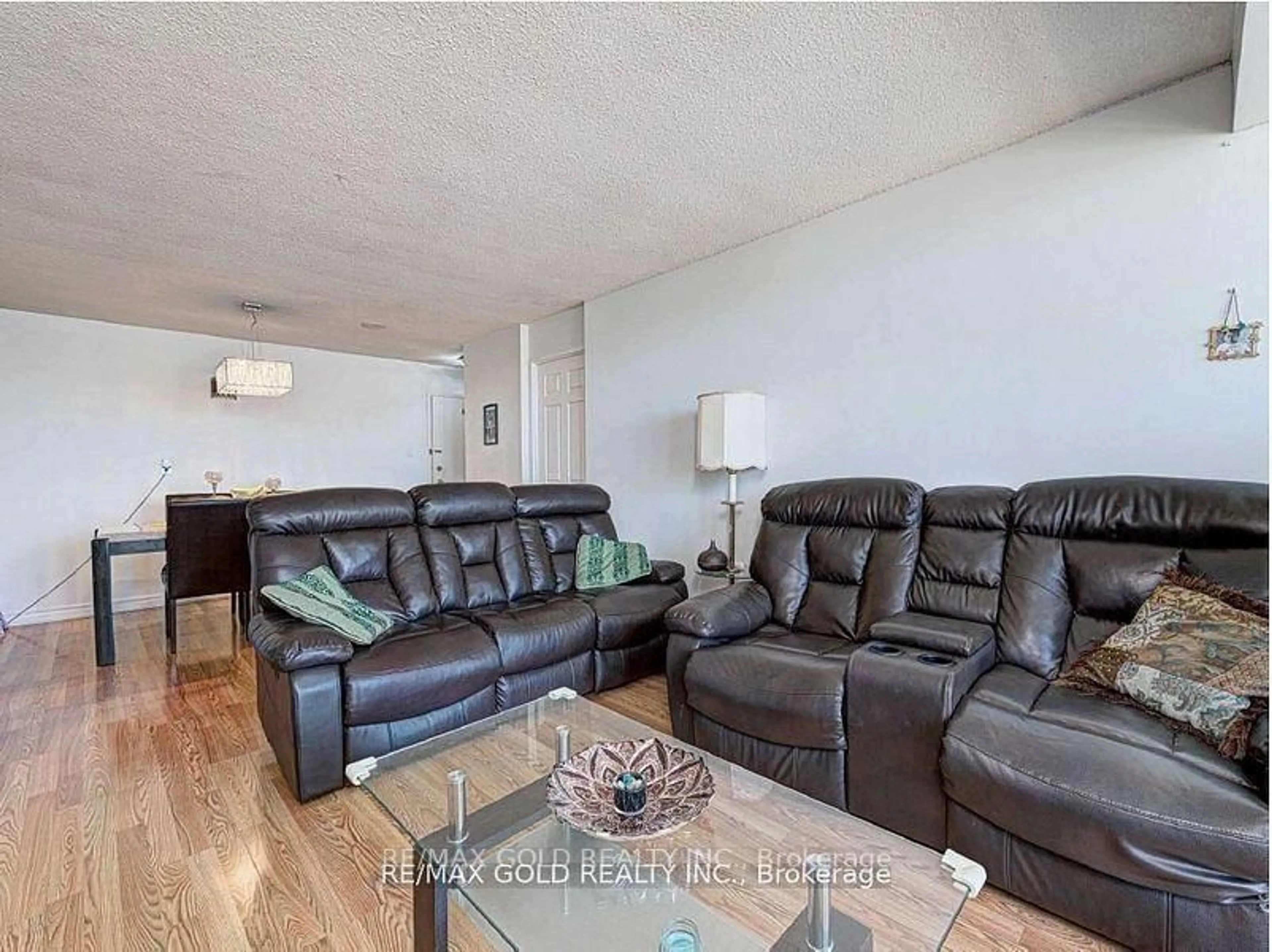Living room with furniture, wood/laminate floor for 10 Tapscott Rd #907, Toronto Ontario M1B 3L9