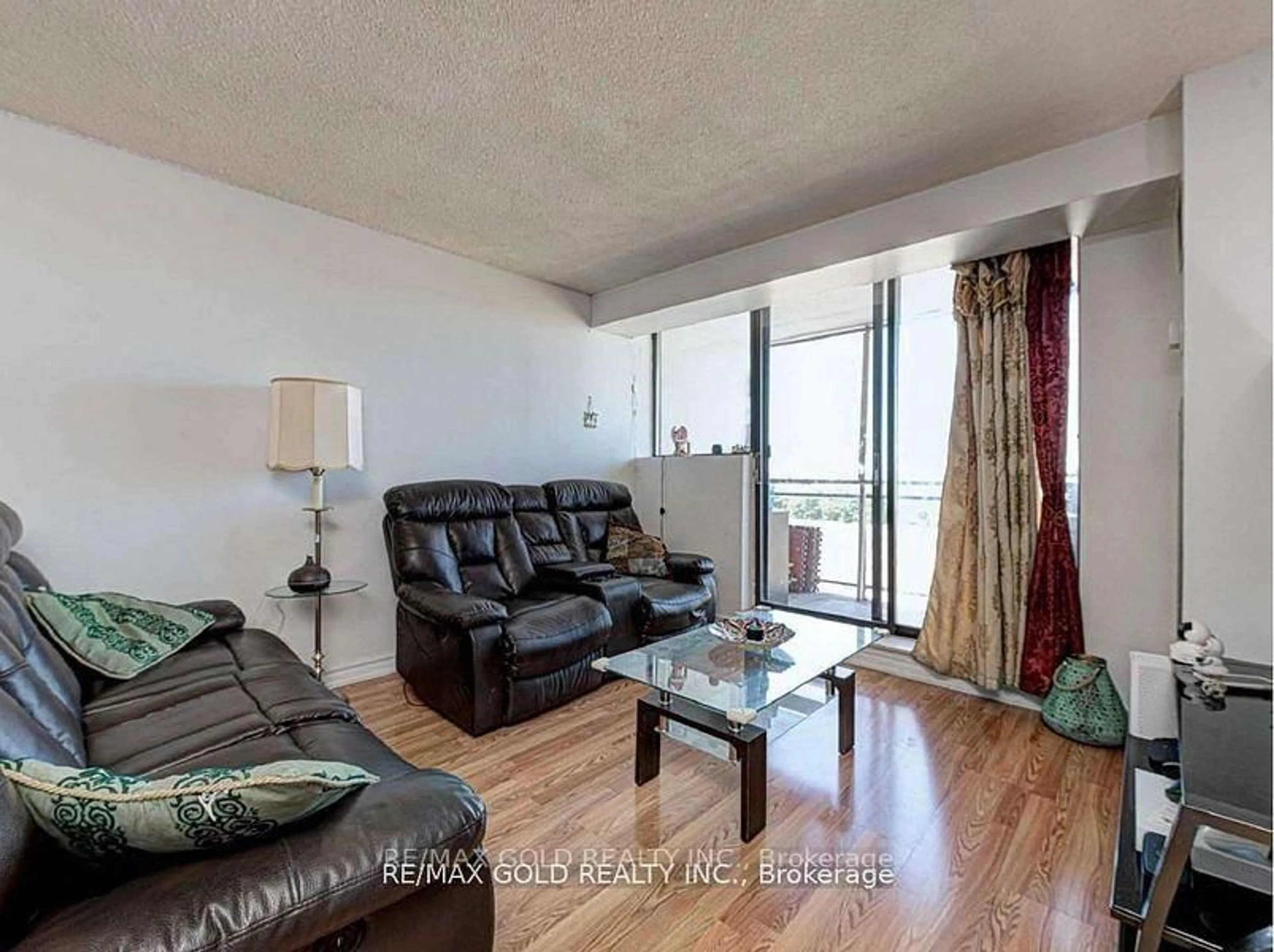 Living room with furniture, wood/laminate floor for 10 Tapscott Rd #907, Toronto Ontario M1B 3L9