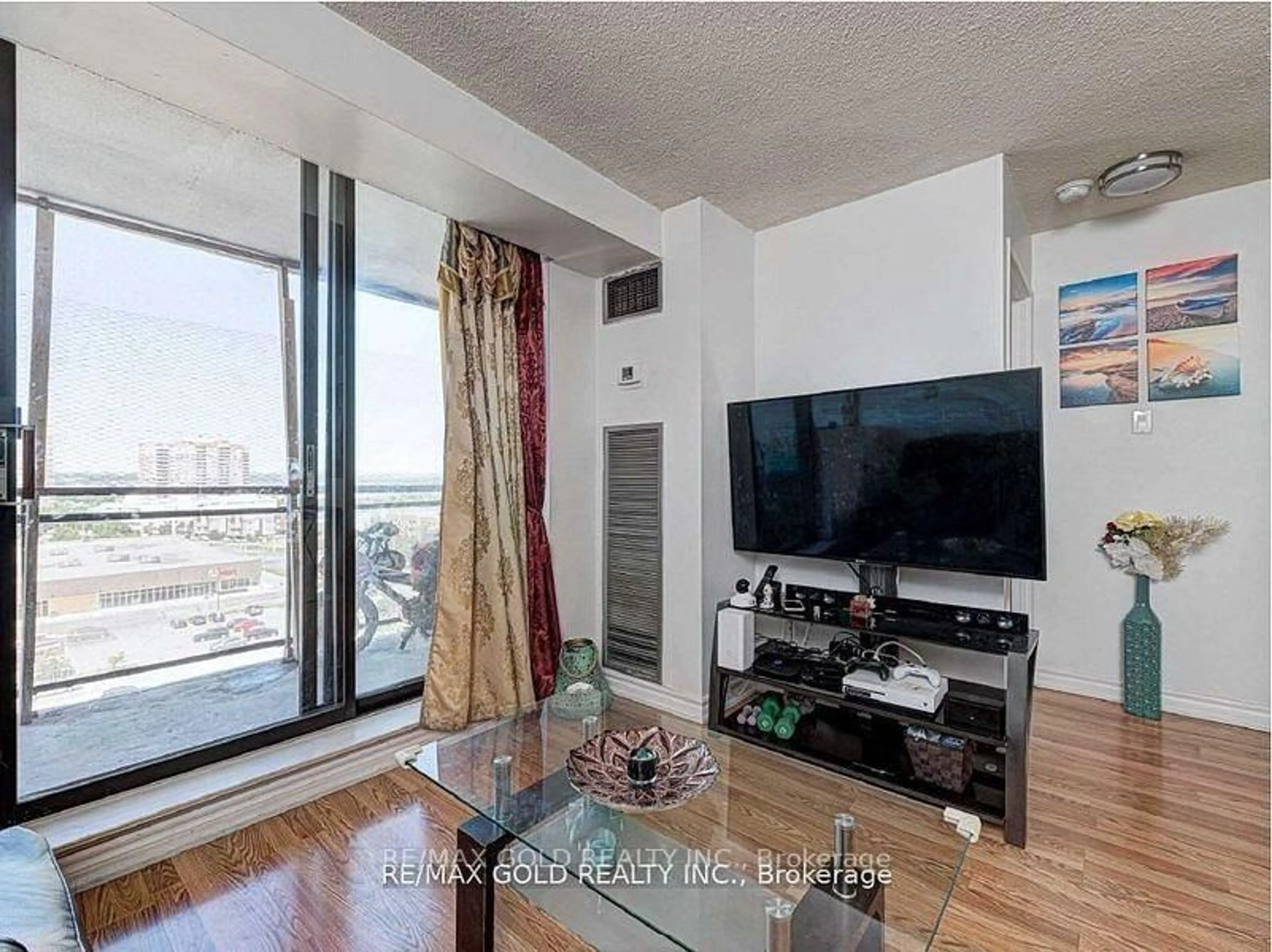 Living room with furniture, wood/laminate floor for 10 Tapscott Rd #907, Toronto Ontario M1B 3L9