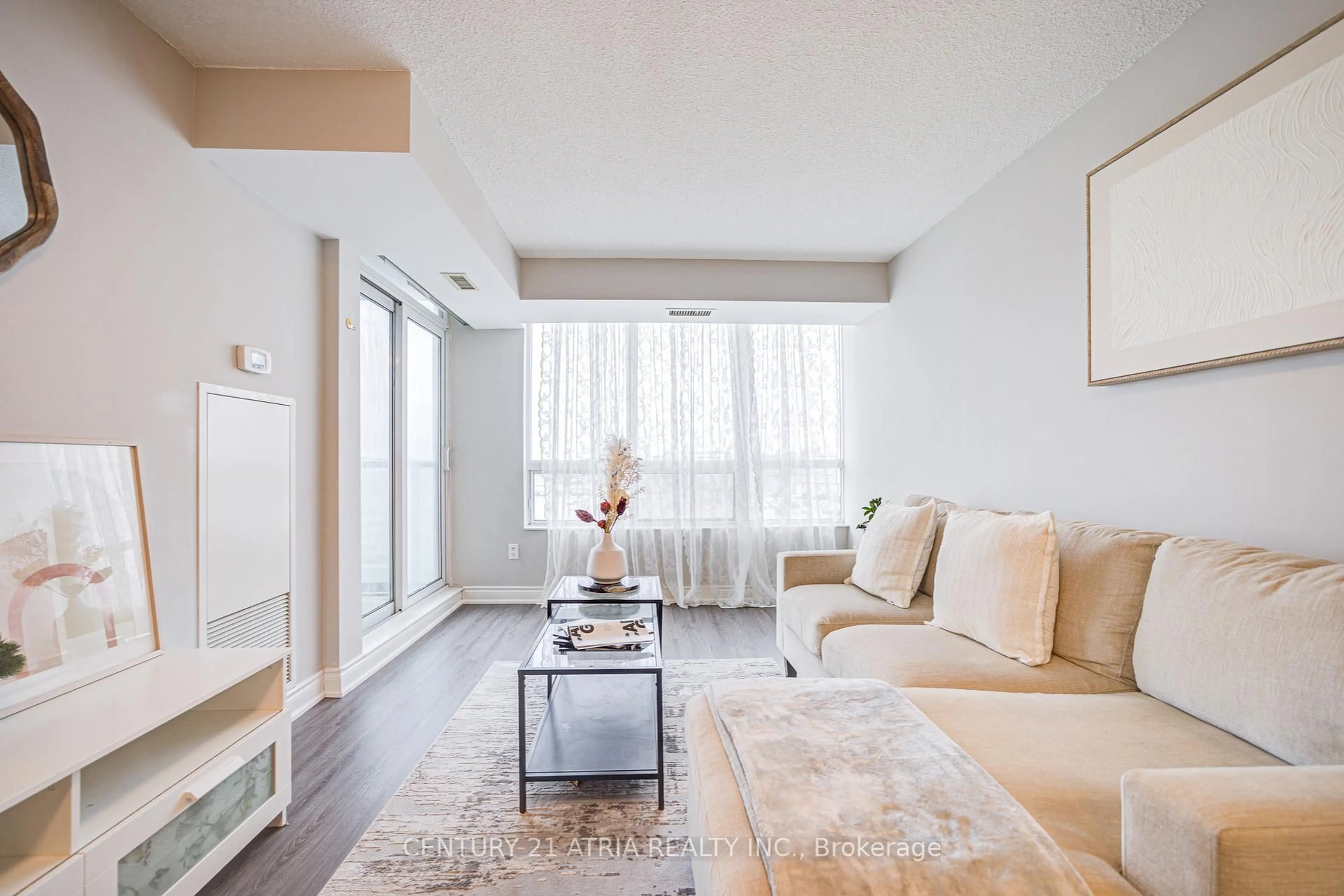Living room with furniture, wood/laminate floor for 50 Brian Harrison Way #407, Toronto Ontario M1P 5J4