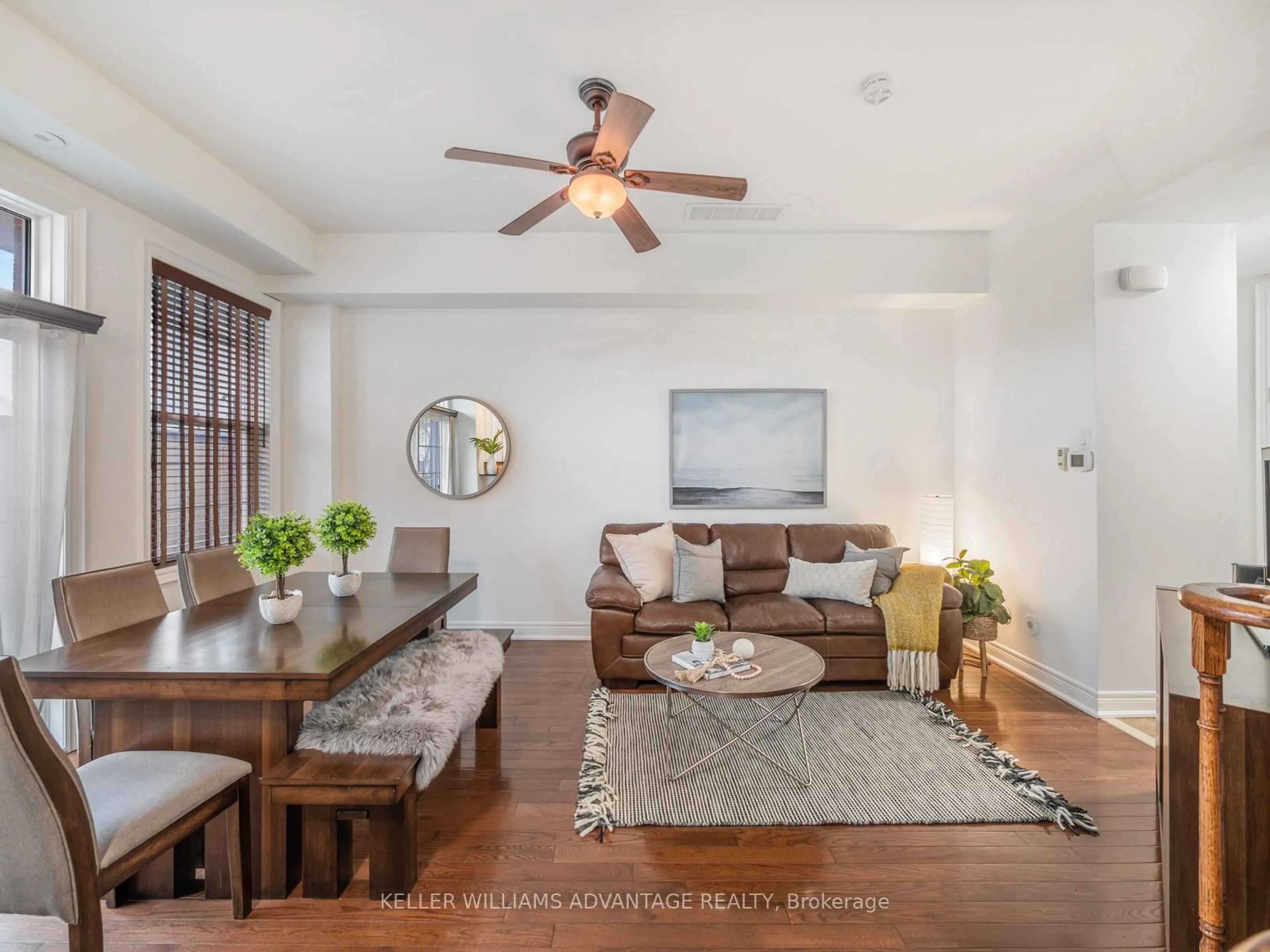 Living room with furniture, wood/laminate floor for 34 Fairhead Mews, Toronto Ontario M4E 3Y4